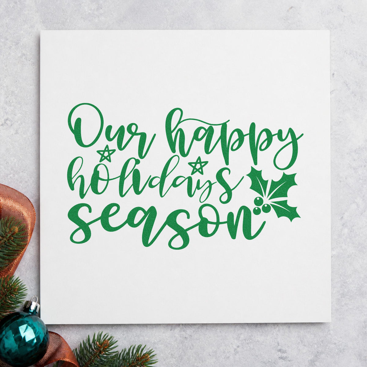 Our Happy Holidays Season craft stamp imprint in green ink on a handmade project, one idea being open house cards.