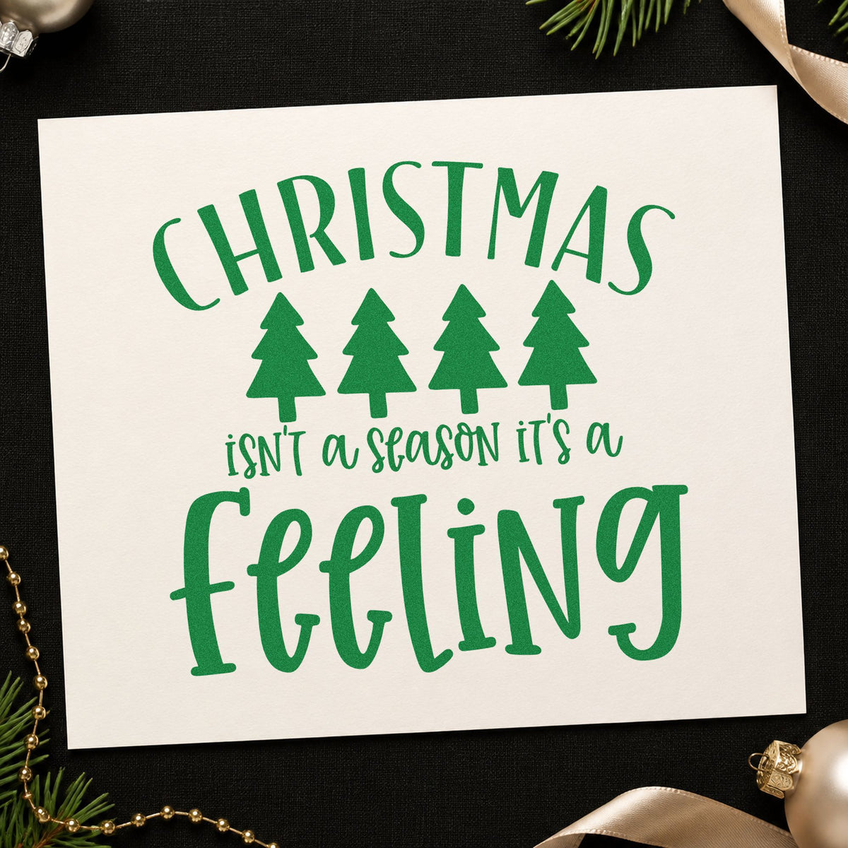 Christmas Is A Feeling craft stamp imprint in green ink on a handmade project, one idea being base border gift tags.