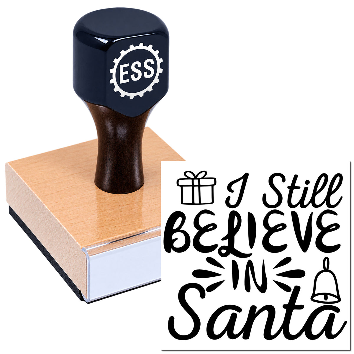 Dark blue ESS rubber stamp on a wooden block, with "I Still Believe in Santa" holiday seal design.