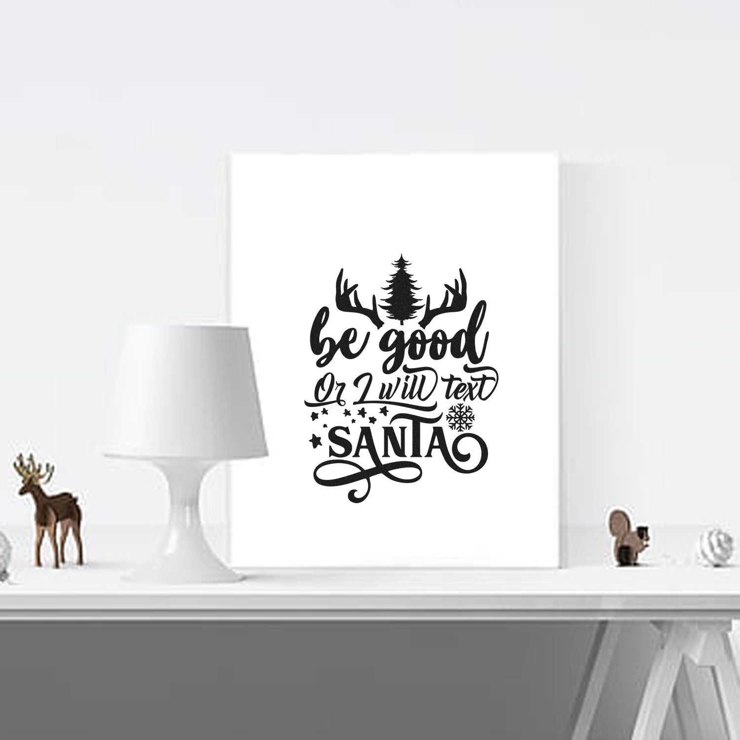 Black holiday stamp and seal design with antlers, pine tree, stars, and be good or I will text Santa on white.