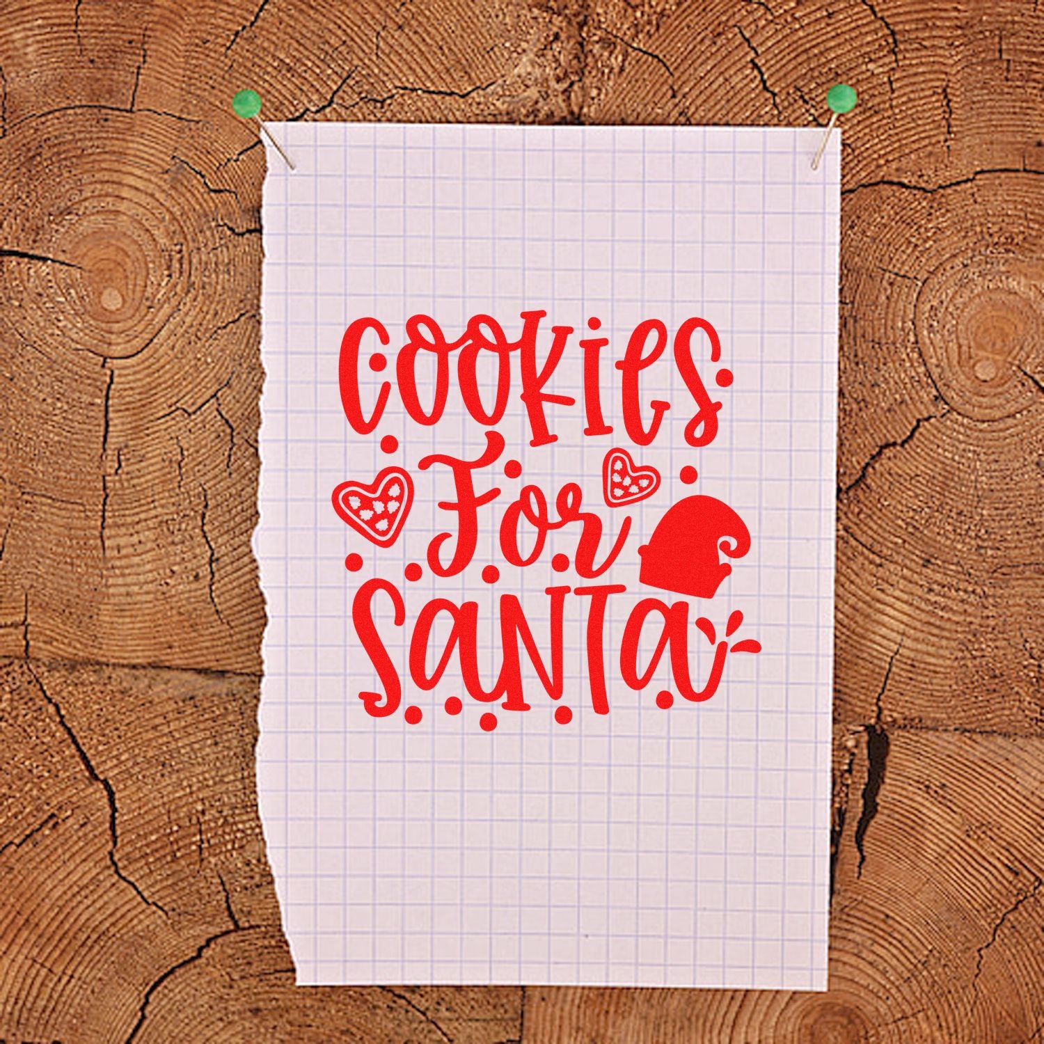 Red Cookies for Santa stamp and seal design with hearts and Santa hat on white grid paper over wood.