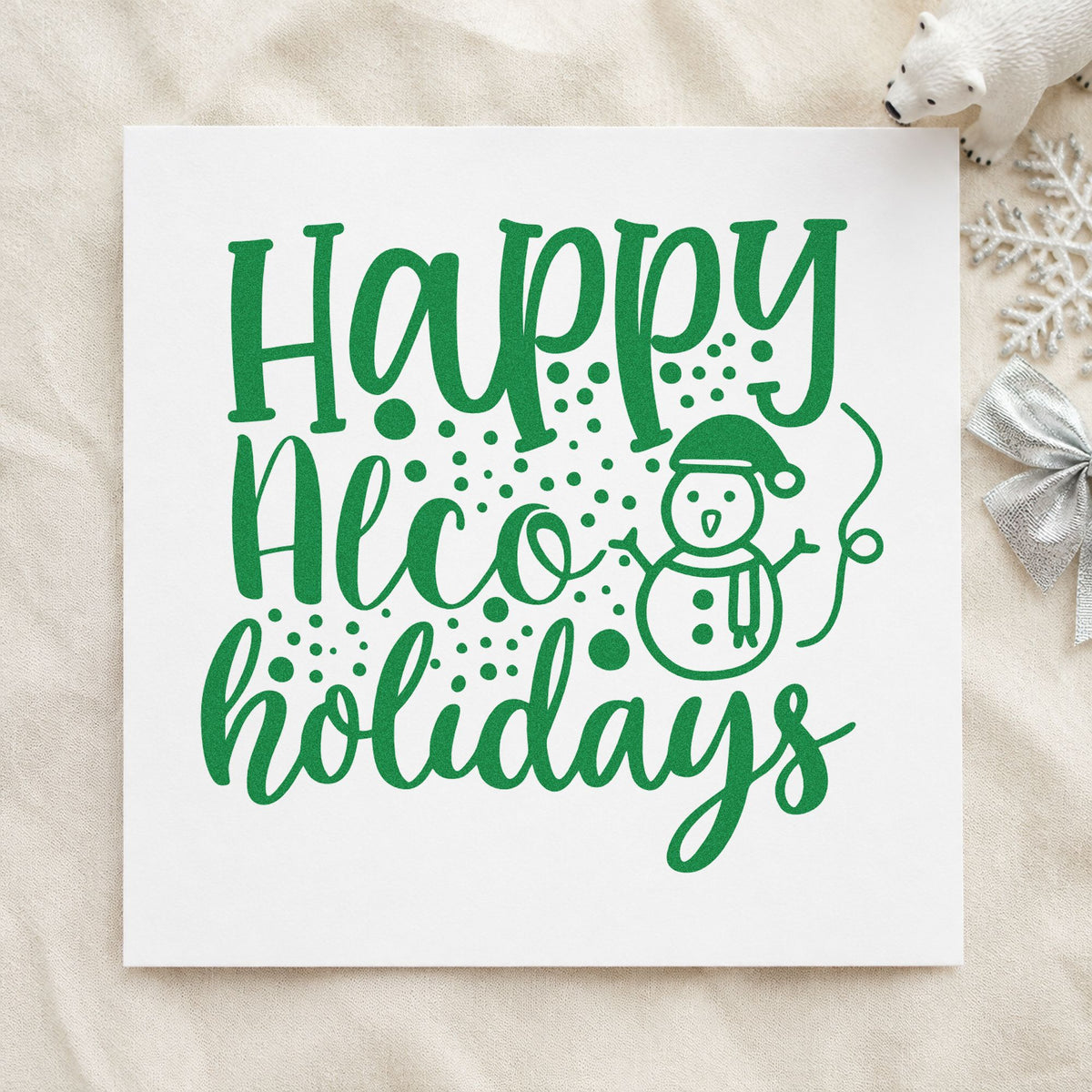 Happy Alco Holidays Snowman craft stamp imprint in green ink on a handmade project, one idea being bottle neck tags.