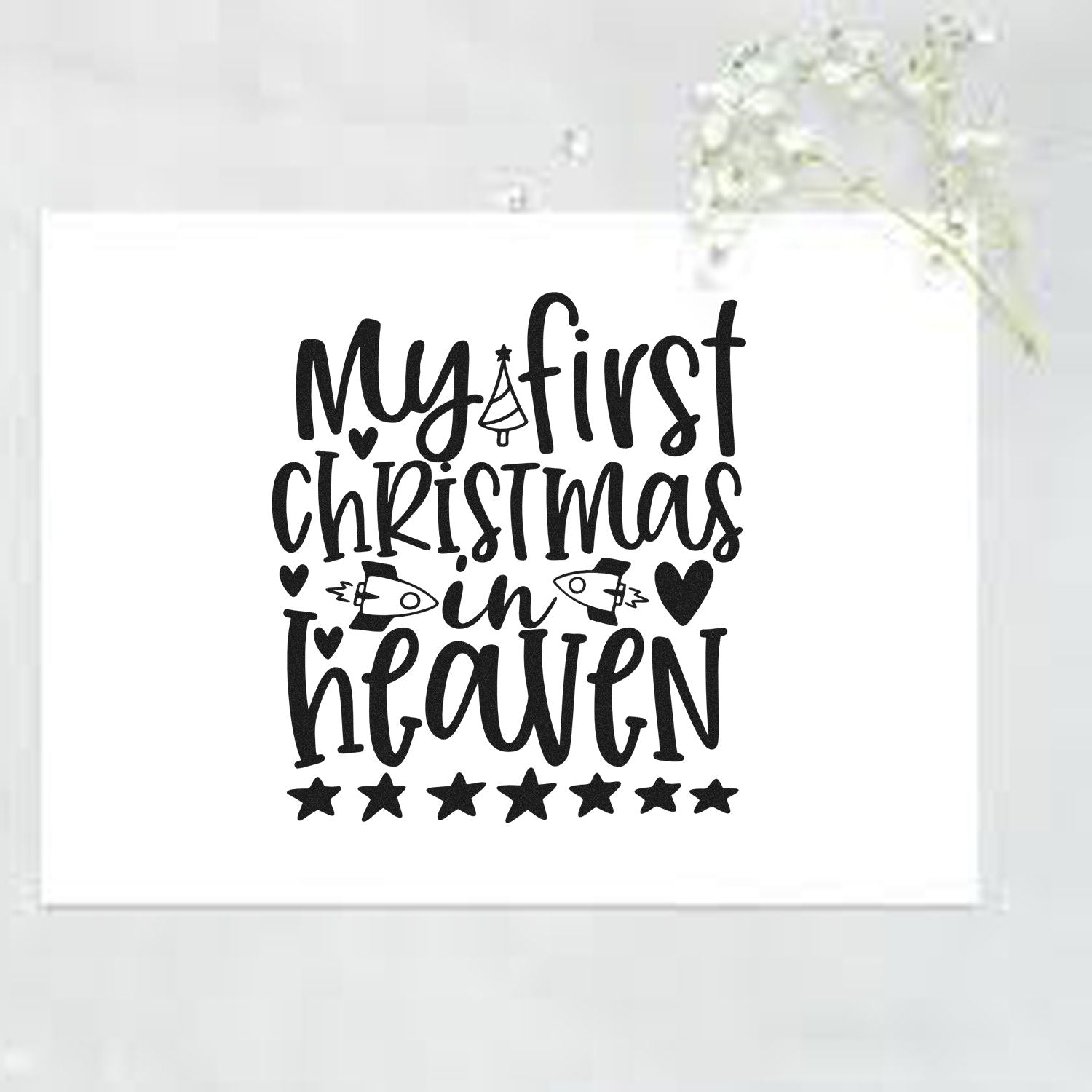 Black My first Christmas in heaven stamp seal design on white, with hearts, stars and festive icons.
