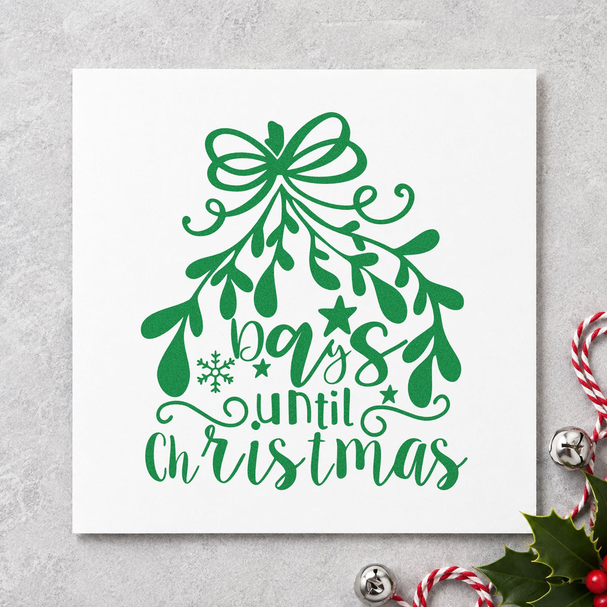 Days Until Christmas Mistletoe craft stamp imprint in green ink on a handmade project, one idea being ribbon loop tags.