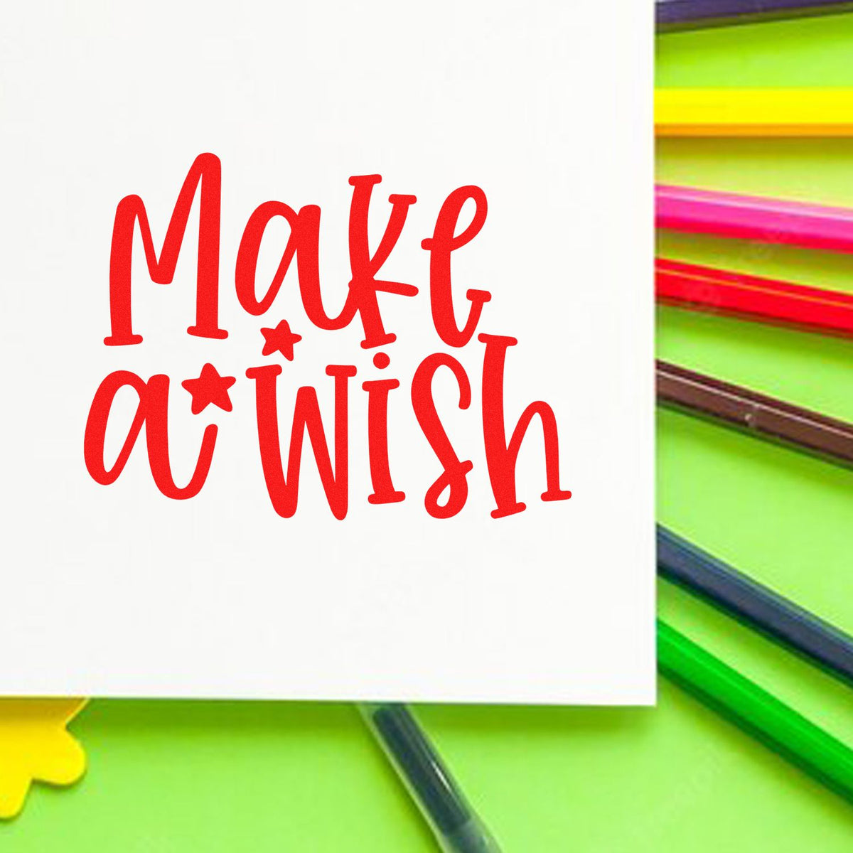 Red Make a Wish stamp on white card with colorful pencils and paper seal accents.