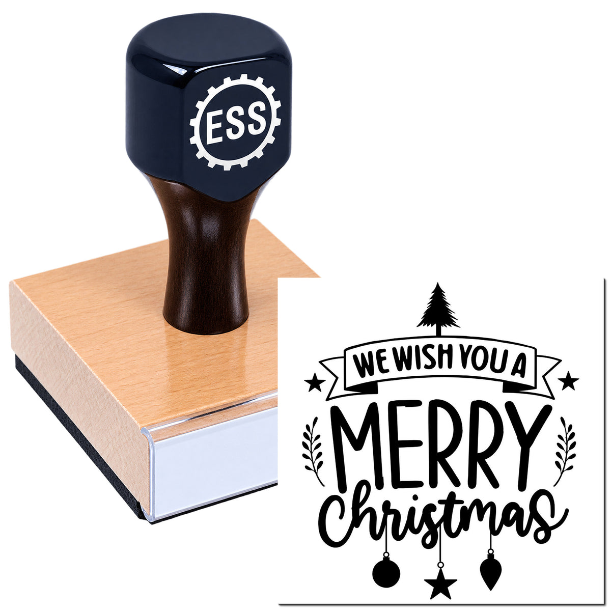 Black ESS rubber stamp on a pink wooden block, printing a Merry Christmas seal with tree, stars, and ornaments.