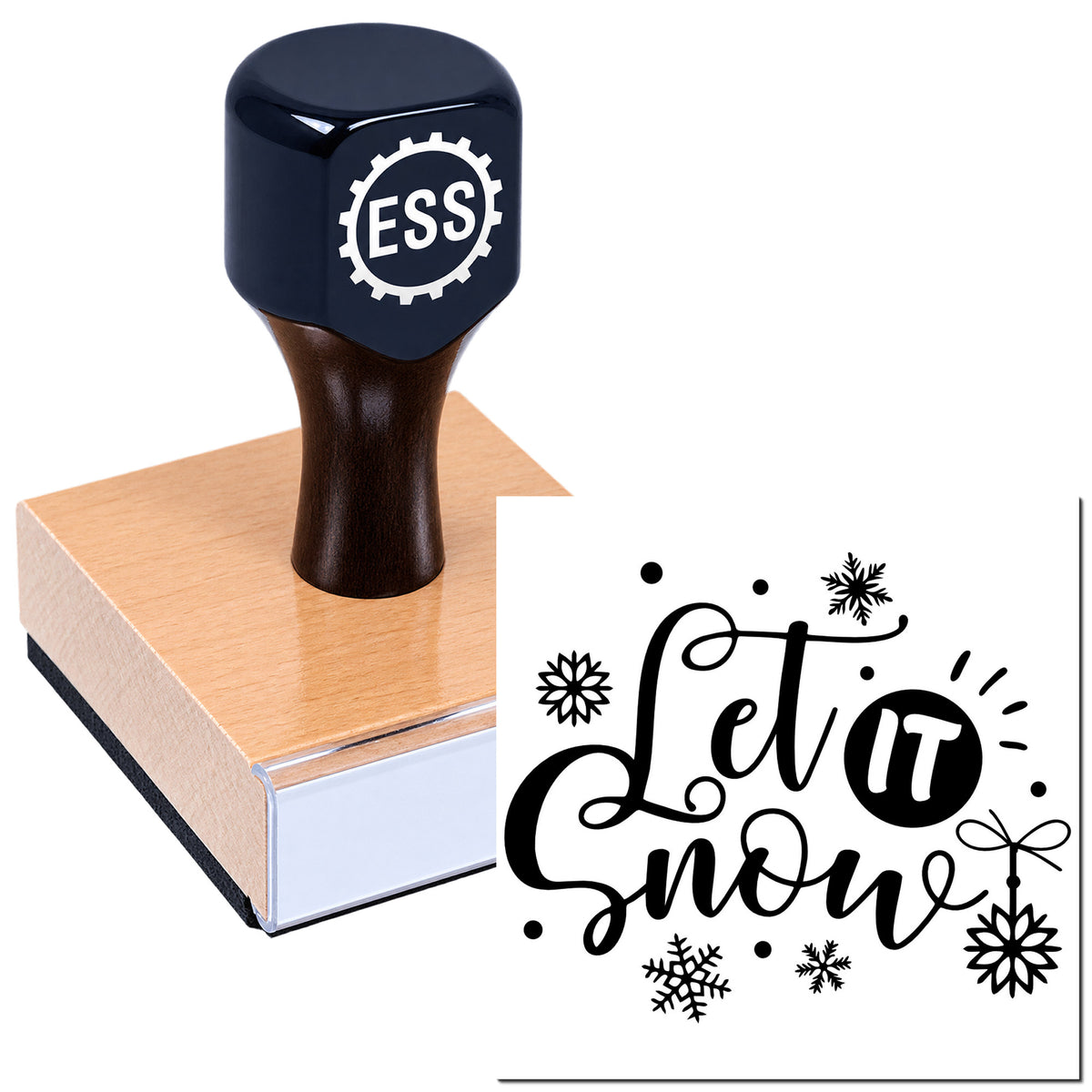 Dark navy rubber stamp on a peach wooden block, making a black "Let it snow" snowflake seal impression
