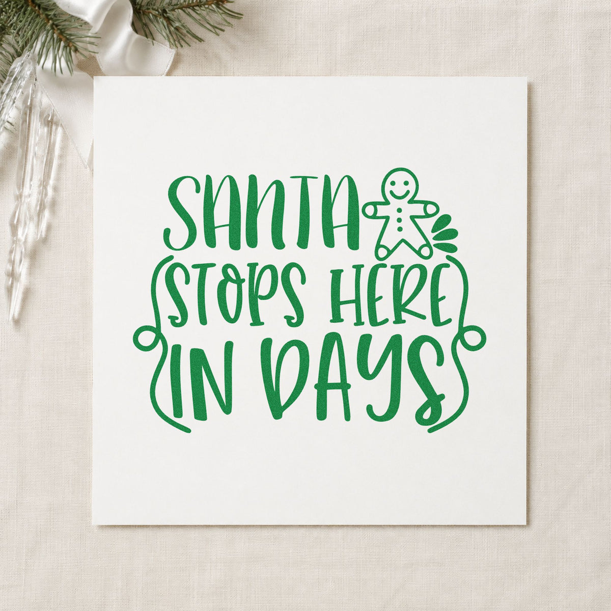 Santa Stops Here In Days craft stamp imprint in green ink on a handmade project, one idea being daily treat tags.