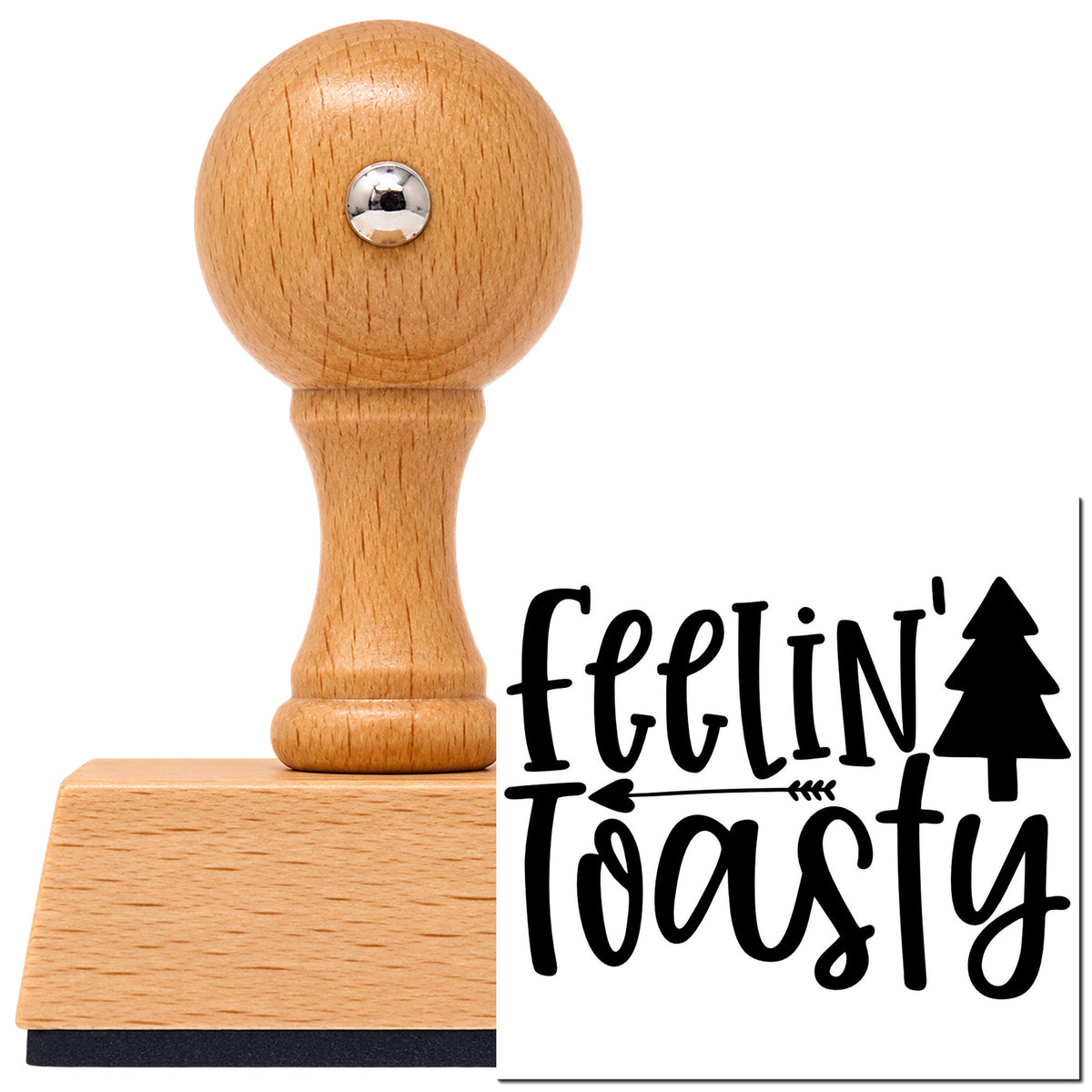 Vintage Pro beech wood stamp with a round knob handle, shown with its black Feelin Toasty Christmas Tree Arrow imprint on white.