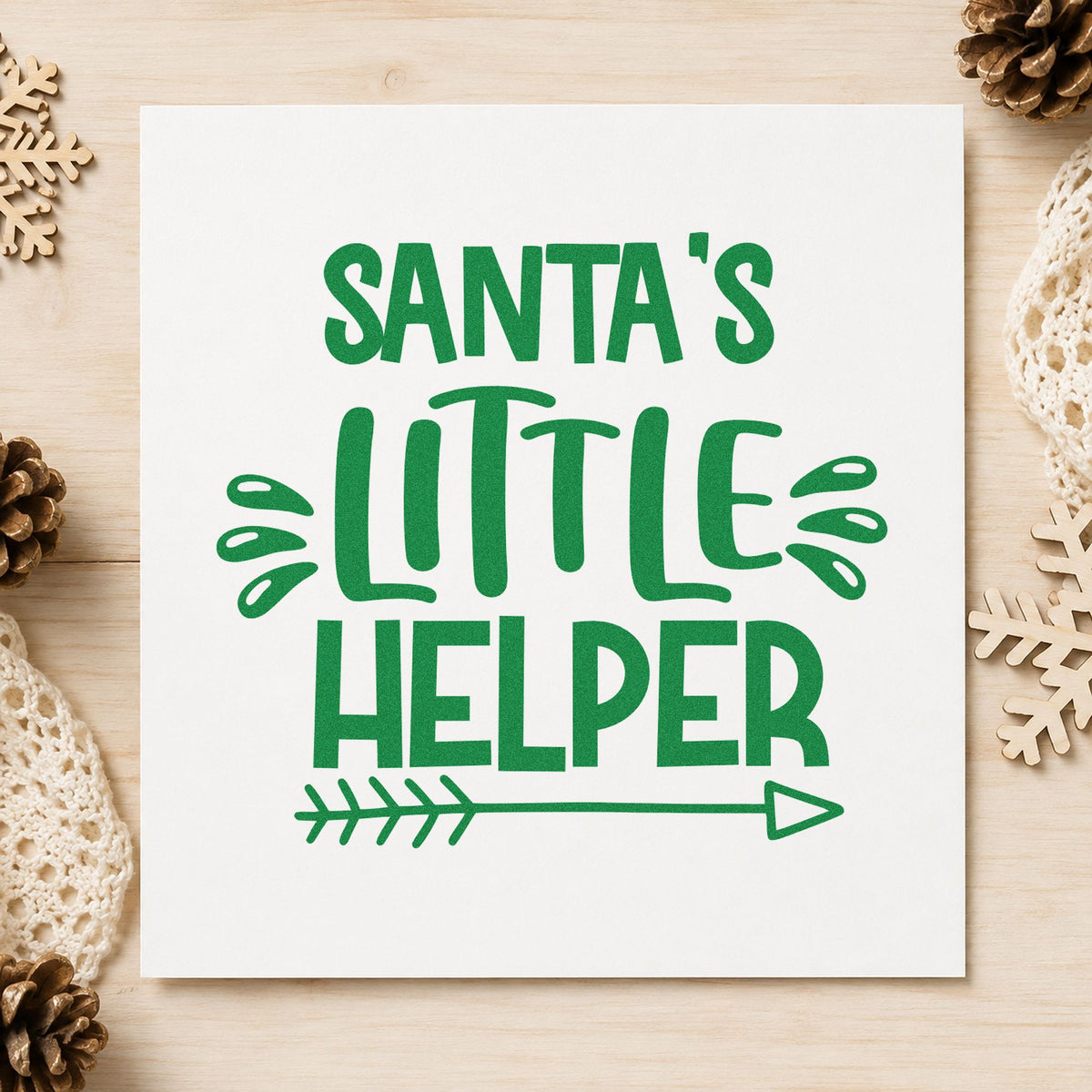 Santa's Little Helper Arrow craft stamp imprint in green ink on a handmade project, one idea being pointed gift tags.