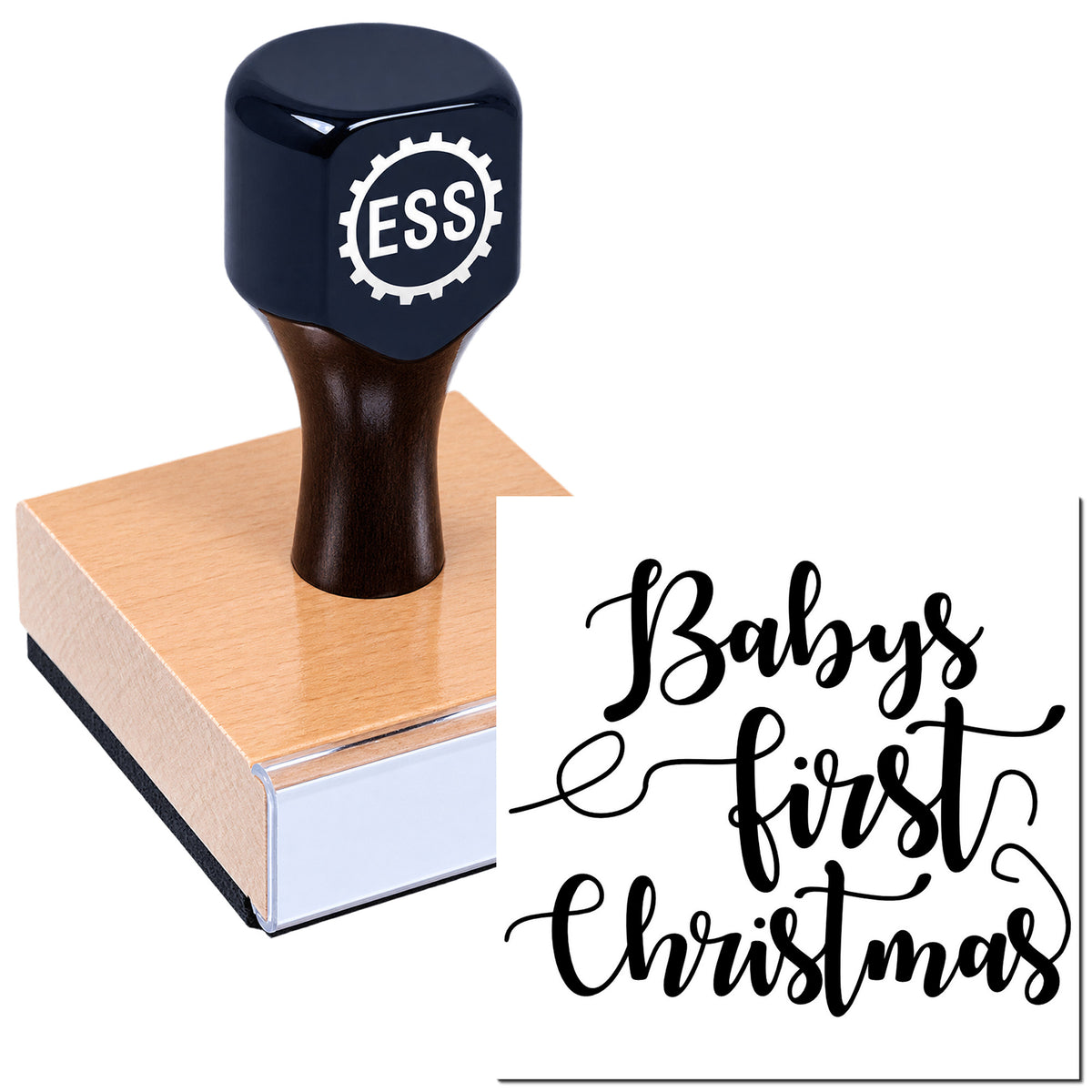 Dark navy ESS stamp and seal on wood block beside black script "Baby's first Christmas"