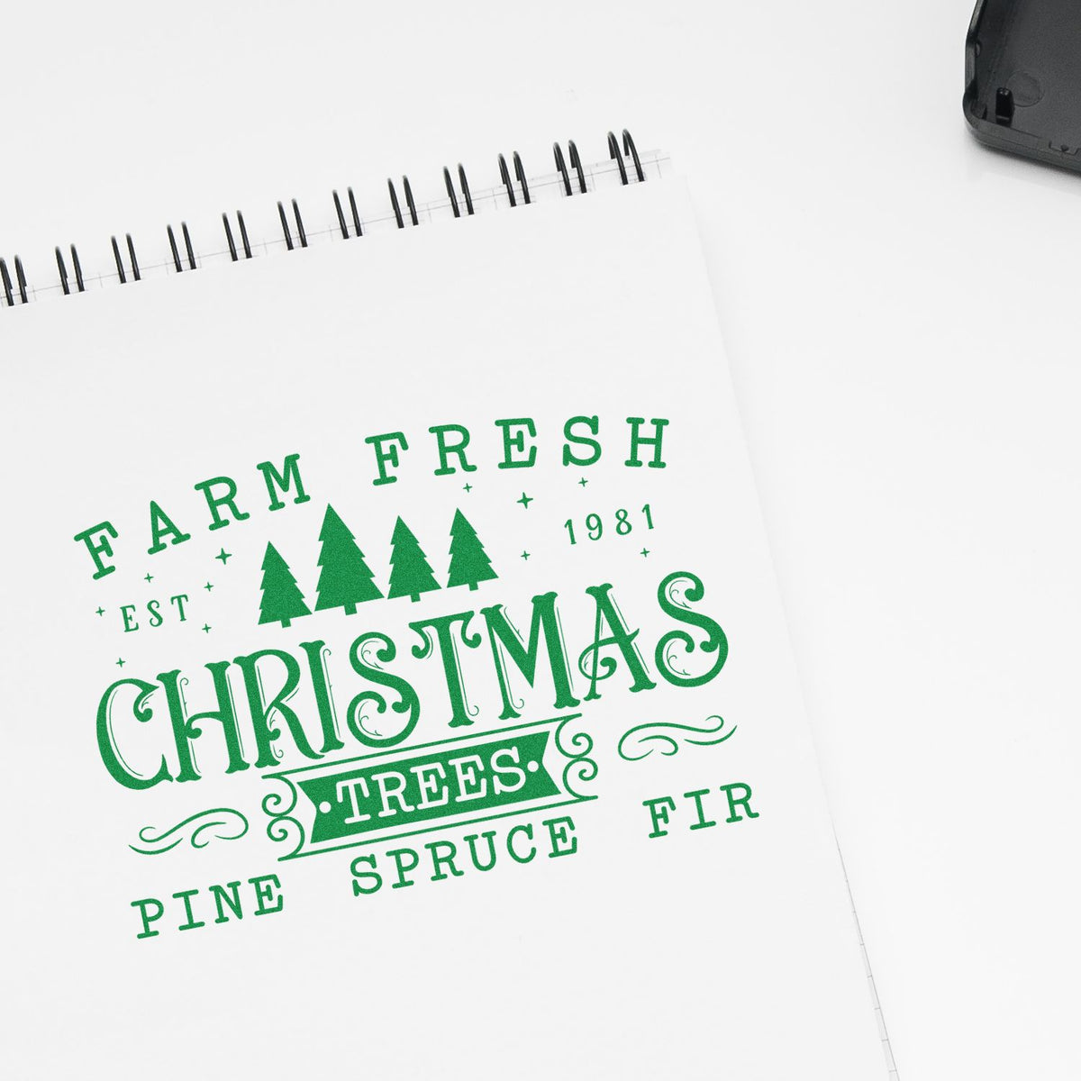Green stamp and seal design reading Farm Fresh Christmas Trees on a white notebook page with pine icons and vintage lettering.