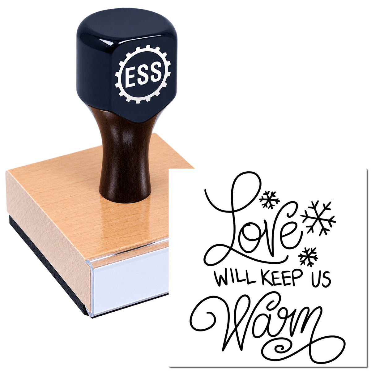 Dark navy ESS stamp and seal on pink wood block, with black "Love will keep us warm" script and snowflake accents.