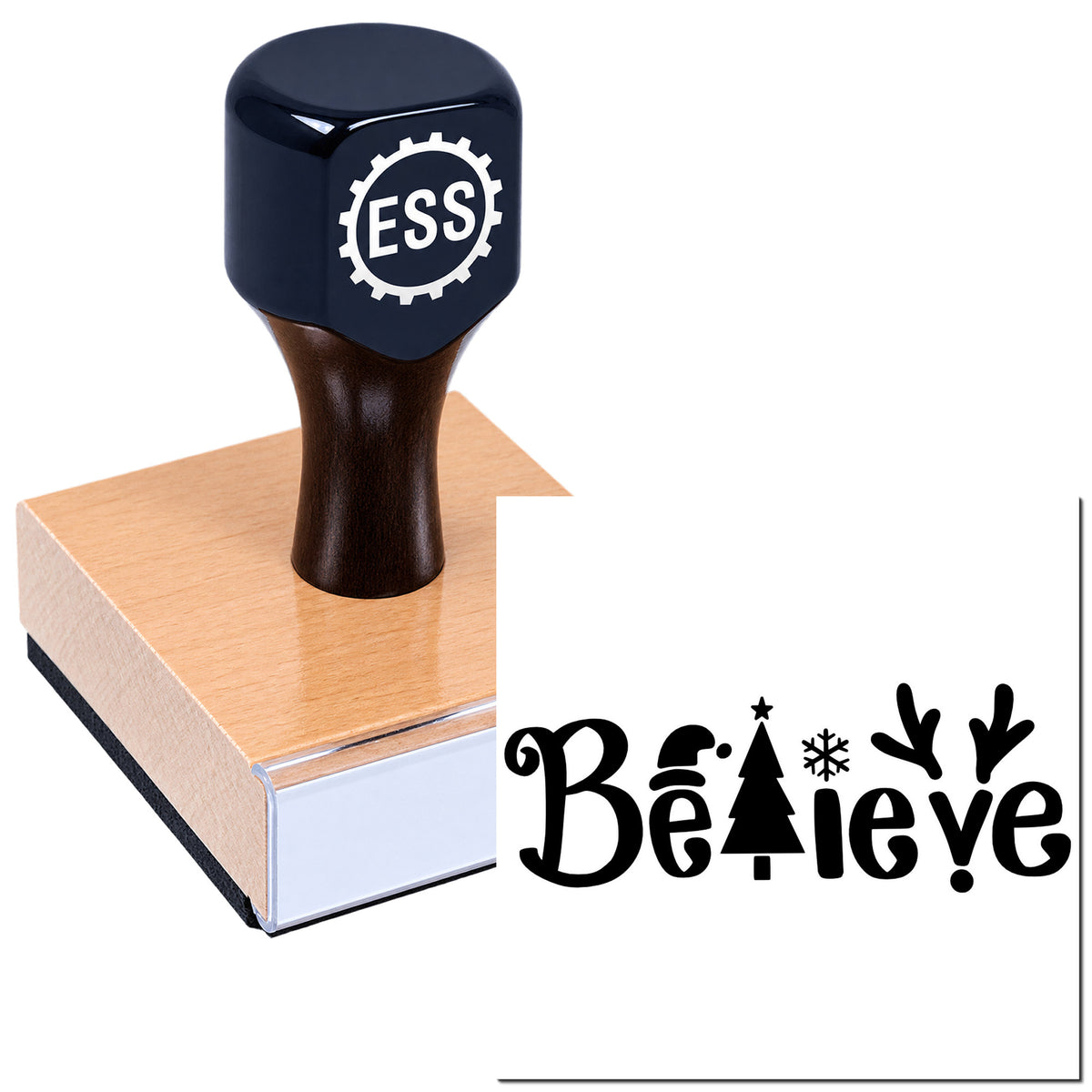 Black ESS rubber stamp on a pink wooden block, featuring a decorative "Believe" seal design with holiday icons.