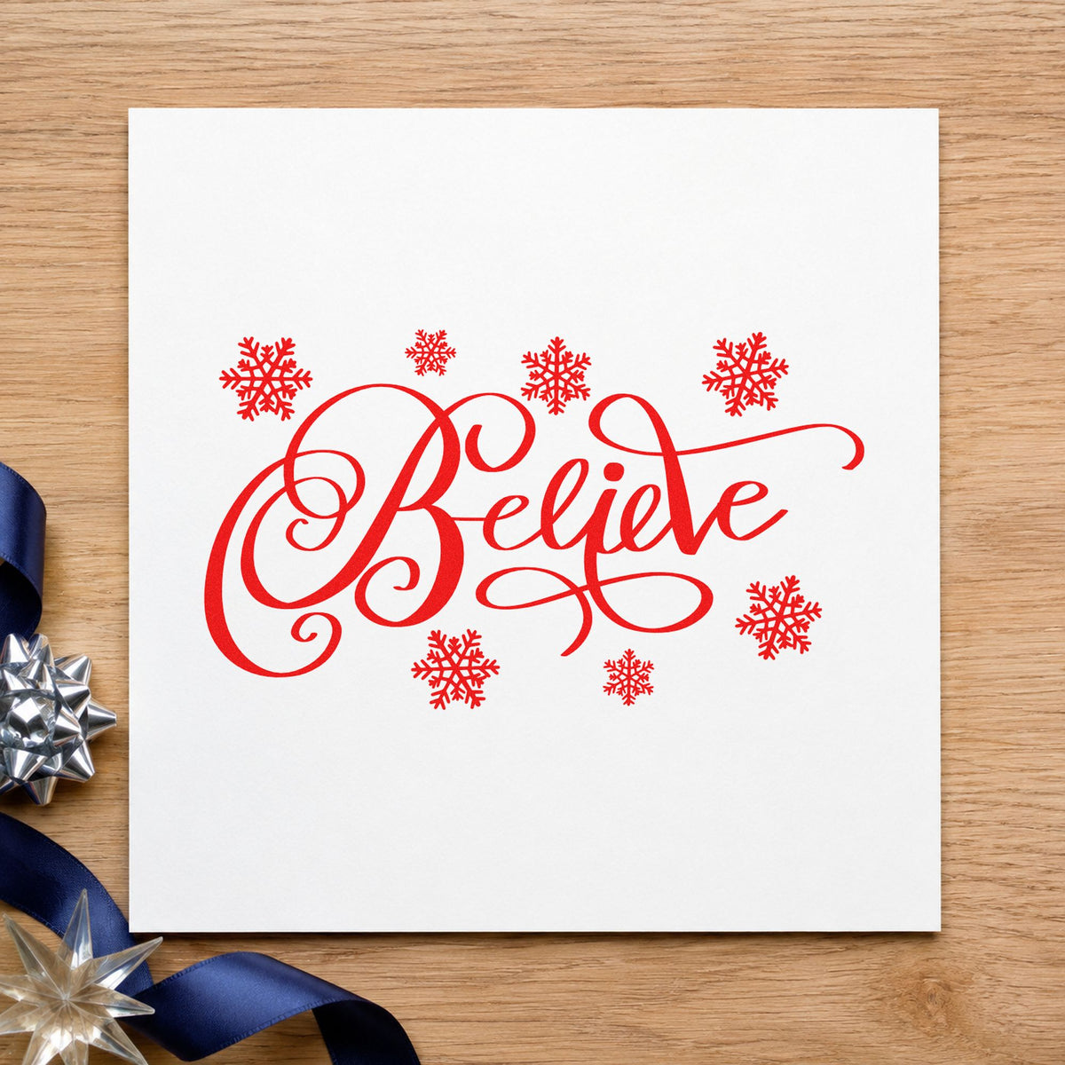 Believe Surrounded By Snowflakes craft stamp in red ink on cardstock, an easy option for sheer panel printing.