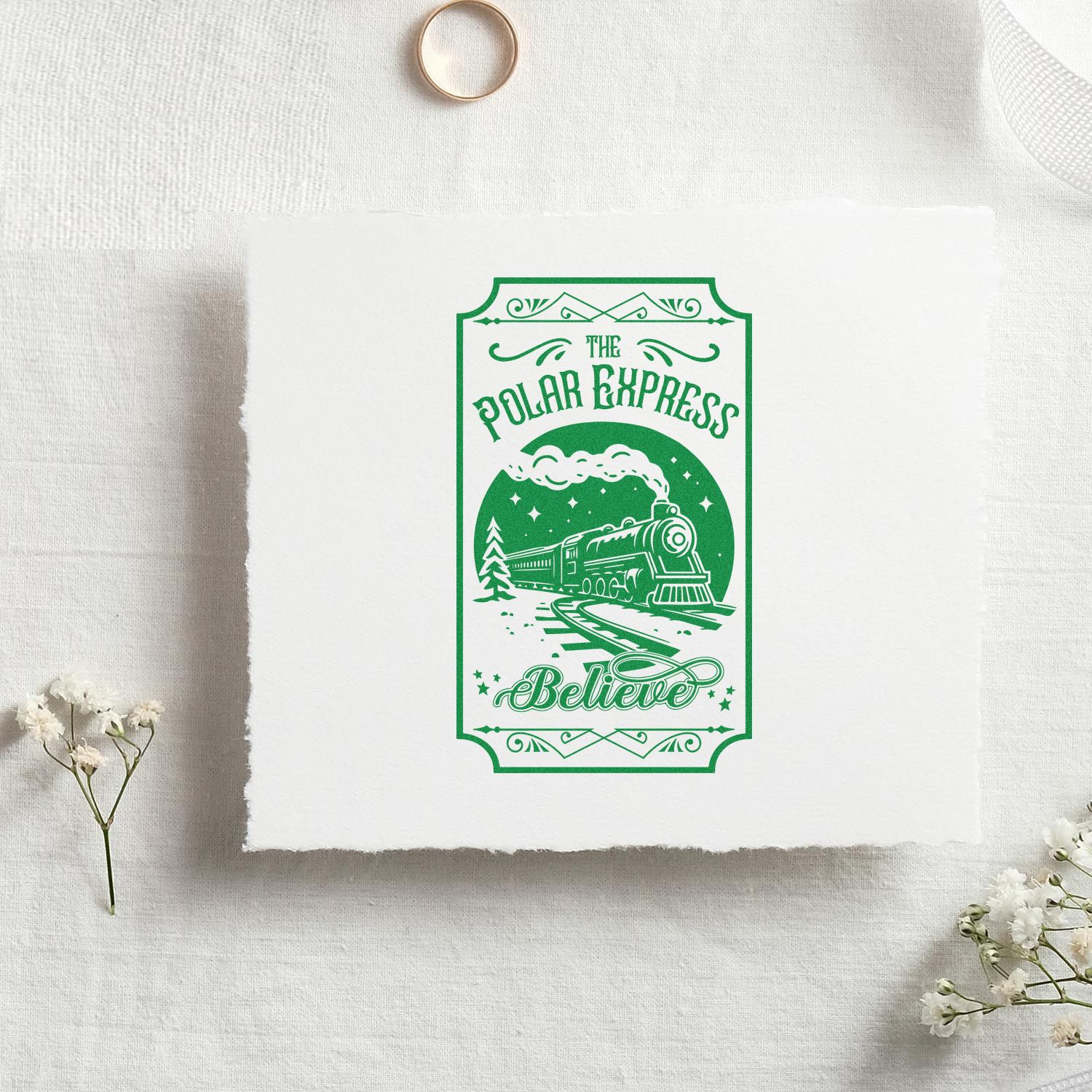 Green Polar Express Believe stamp-and-seal design with steam train on white paper