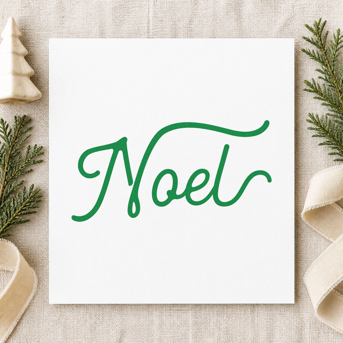 Noel Flowing Script craft stamp imprint in green ink on a handmade project, one idea being formal dinner menus.