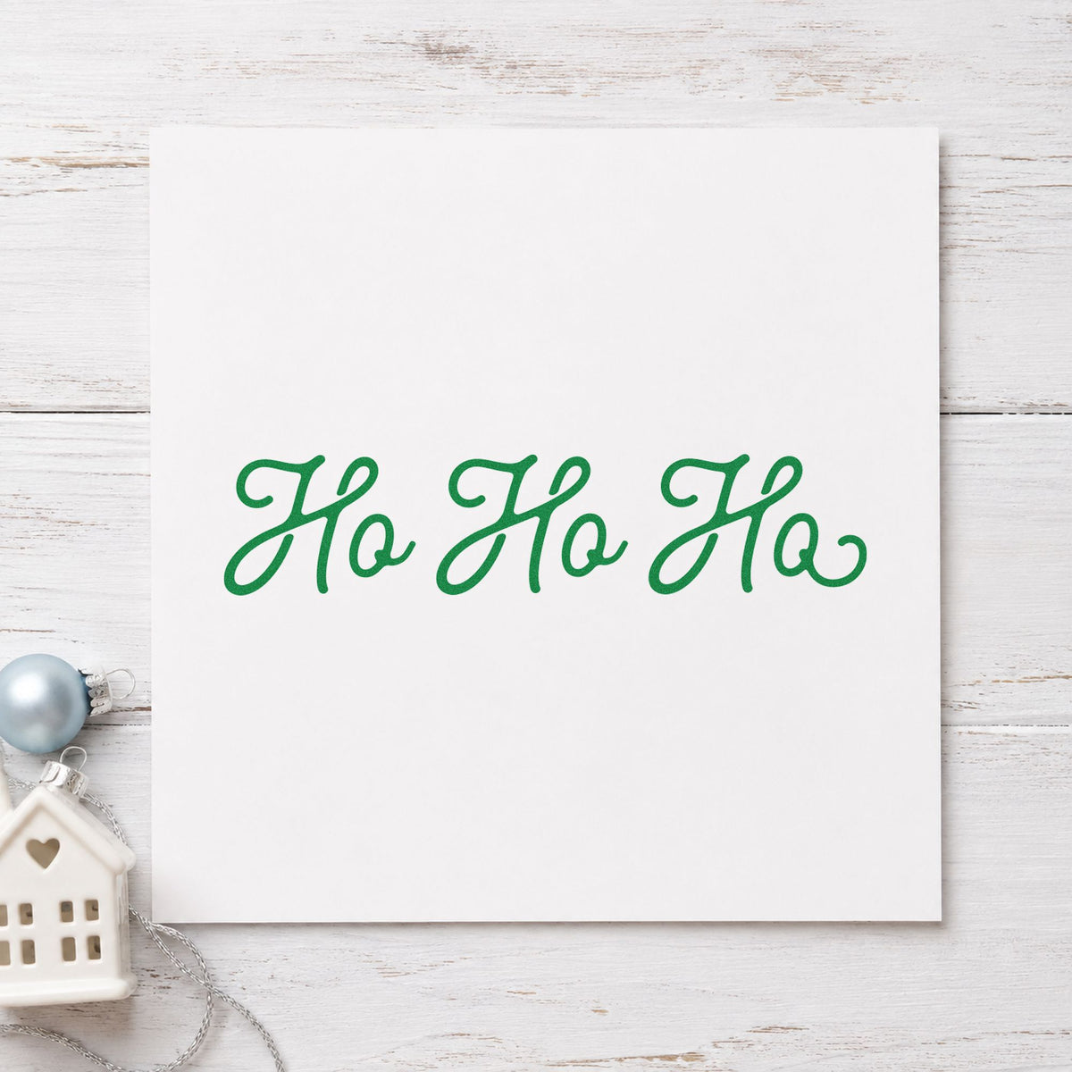 Ho Ho Ho Script craft stamp imprinted in green ink on paper, a design suited to framed narrow strip.