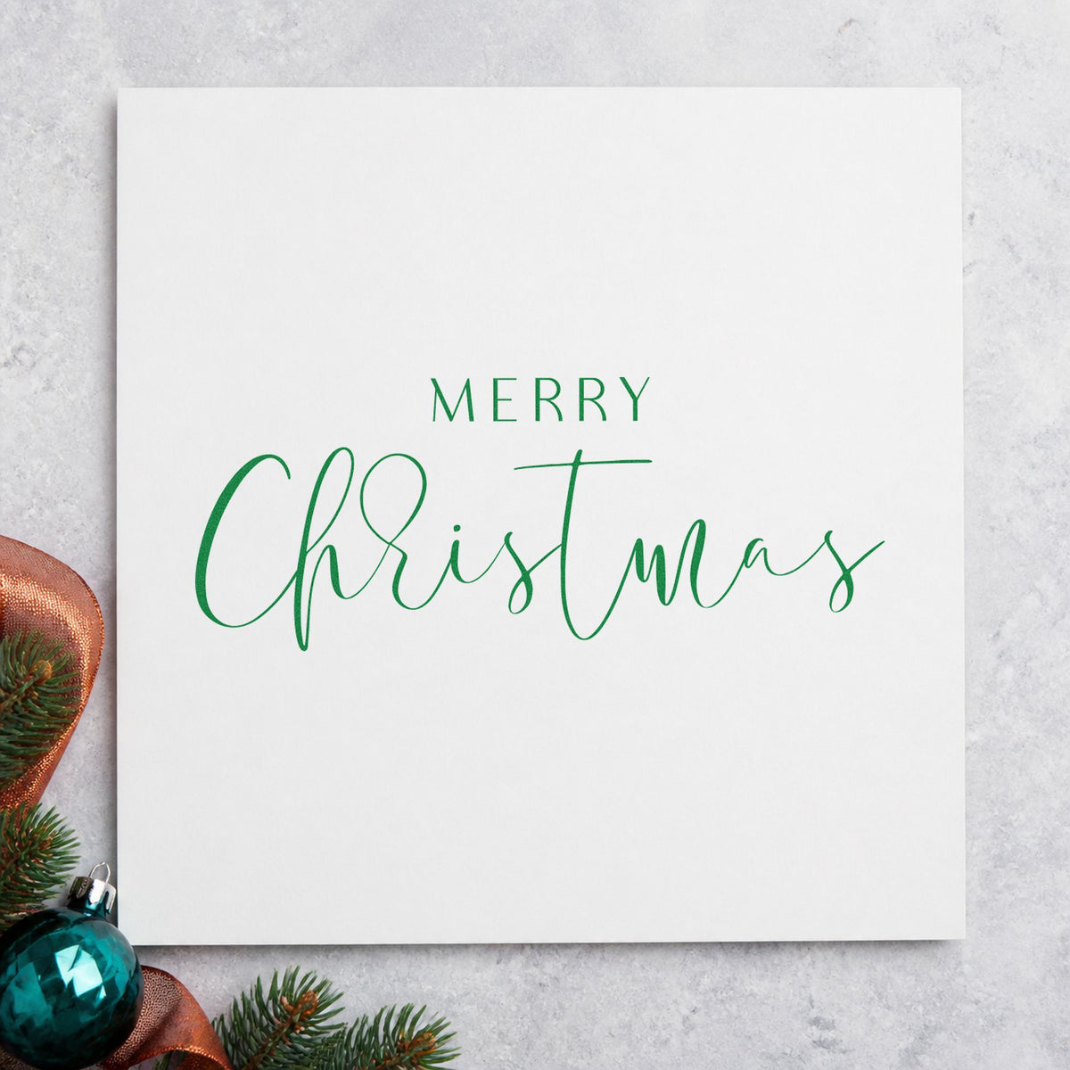 Merry Christmas Fine Script craft stamp imprint in green ink on a handmade project, one idea being reception table cards.