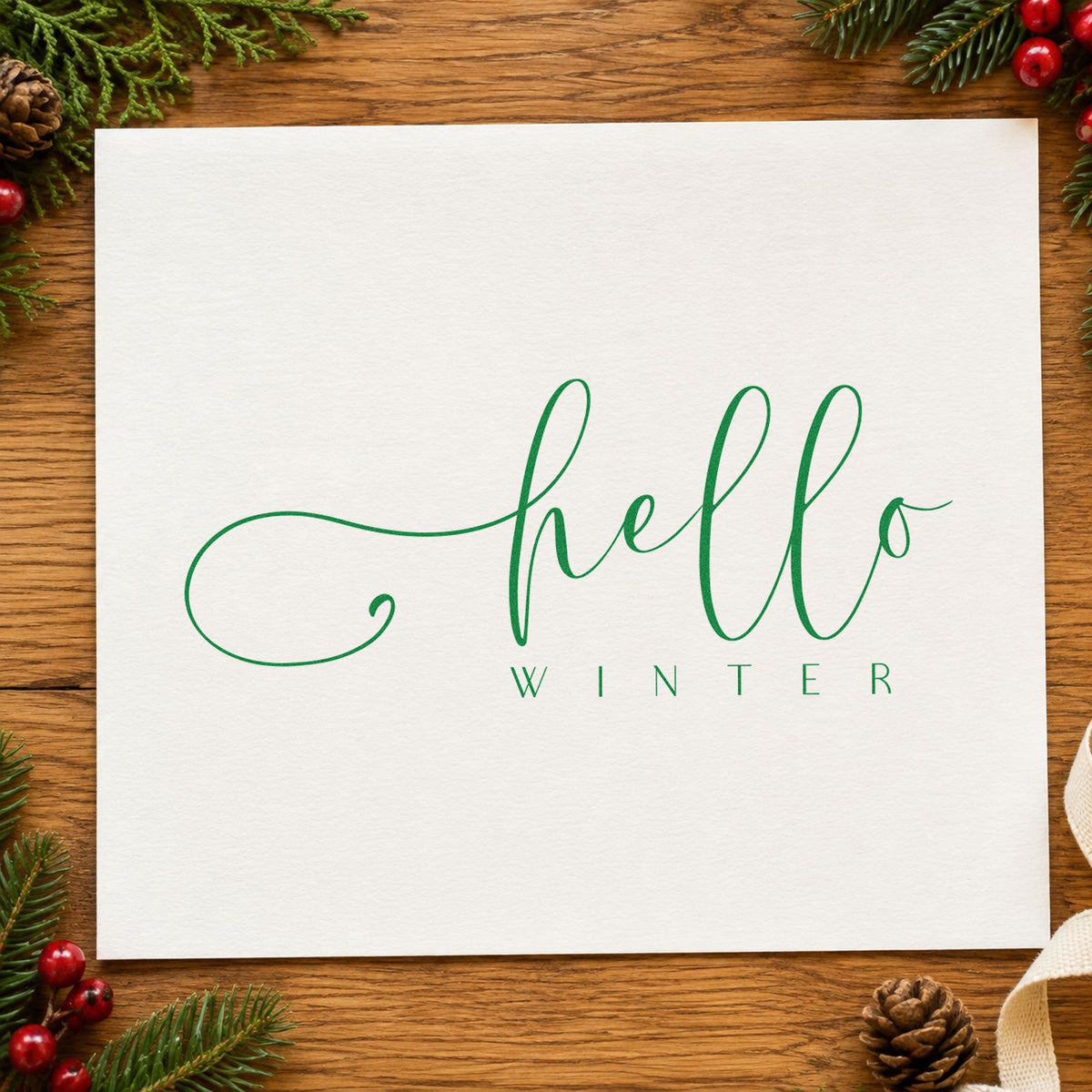 Hello Winter Fine Script craft stamp imprint in green ink on a handmade project, one idea being care slip cards.