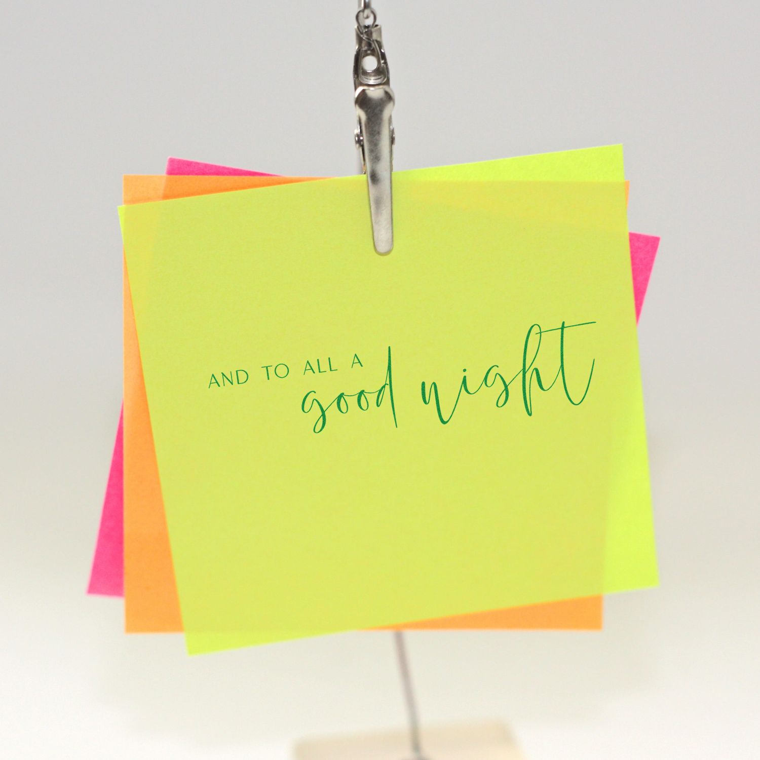 Neon yellow stamp-seal card with green good night text, clipped over orange and pink notes.
