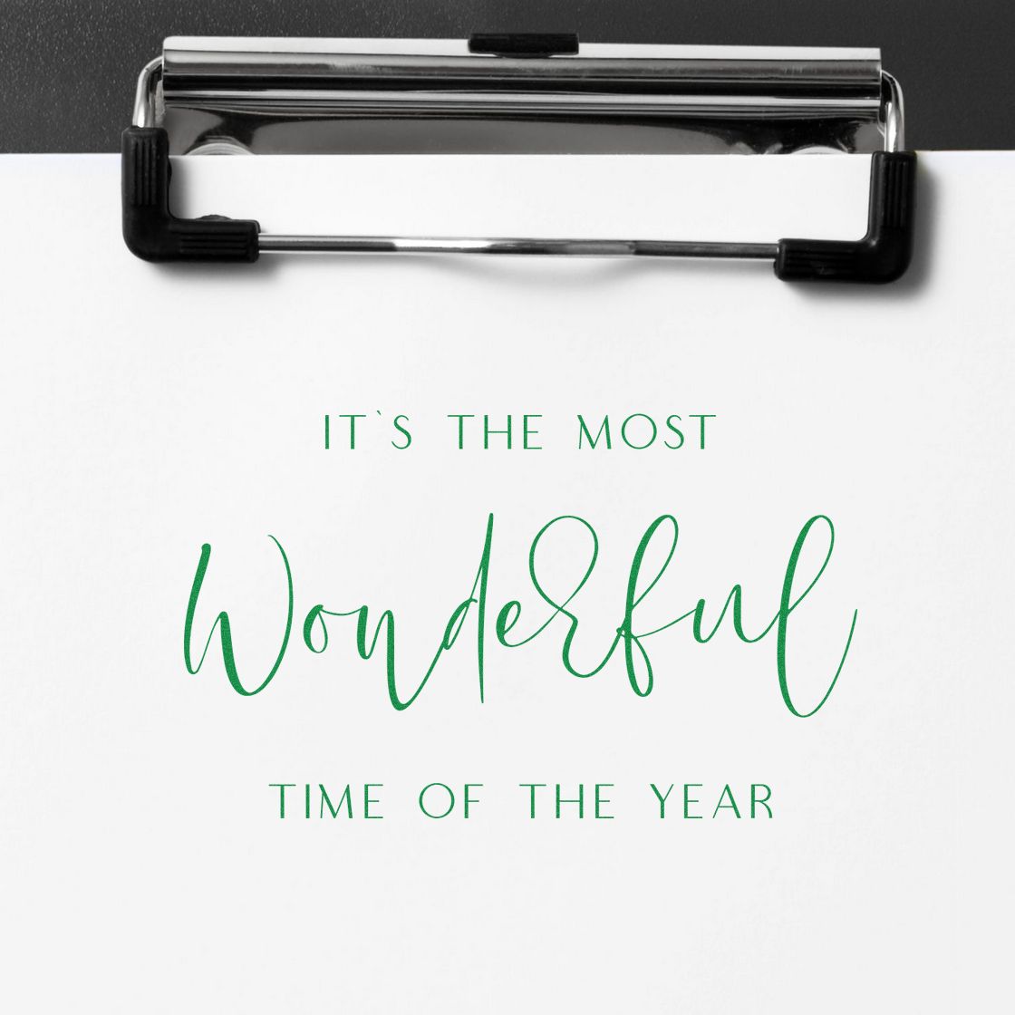 Clipboard holding a white sheet with green holiday stamp and seal text: Its the Most Wonderful Time of the Year.