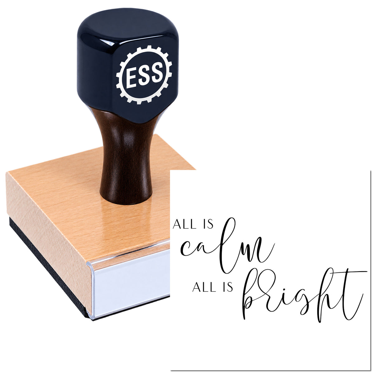 Dark navy ESS stamp seal on a pink wooden block beside "All is calm, all is bright" script