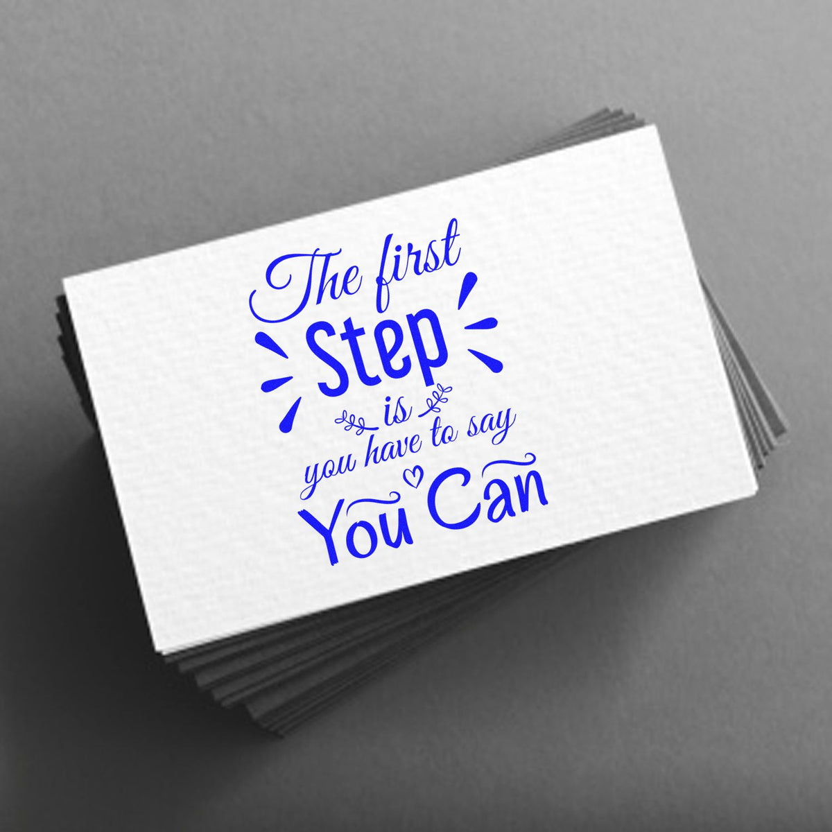 Stacked white custom stamp-and-seal cards with blue The first Step
You Can lettering on a gray background.