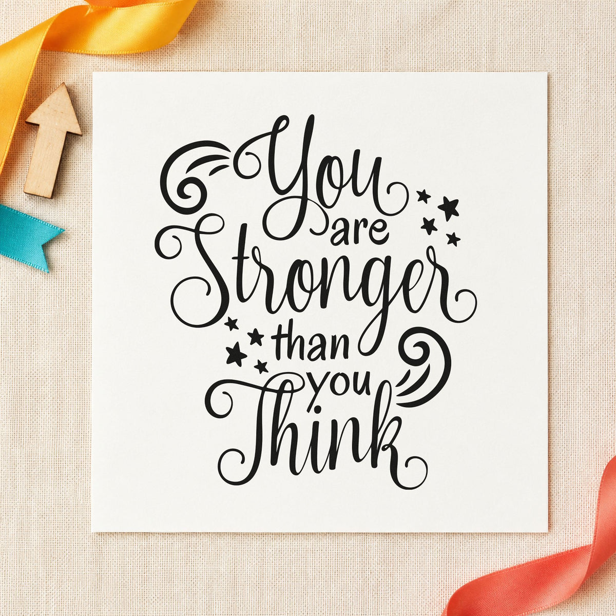 Stronger Than You Think craft stamp imprint in black ink on a handmade project, one idea being fuel pack gift tags.