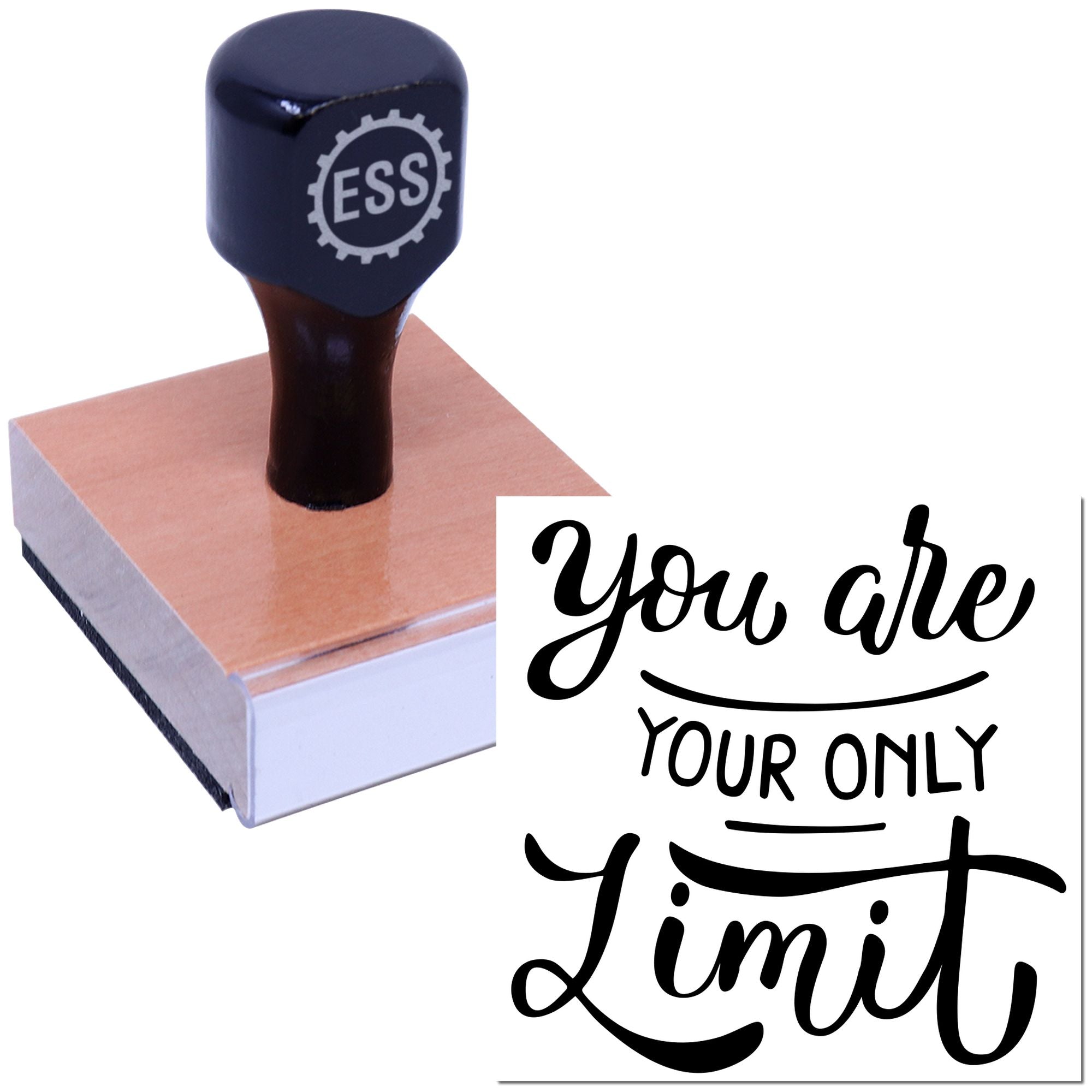 Black ESS rubber stamp on pink wooden block, with You are your only limit seal imprint