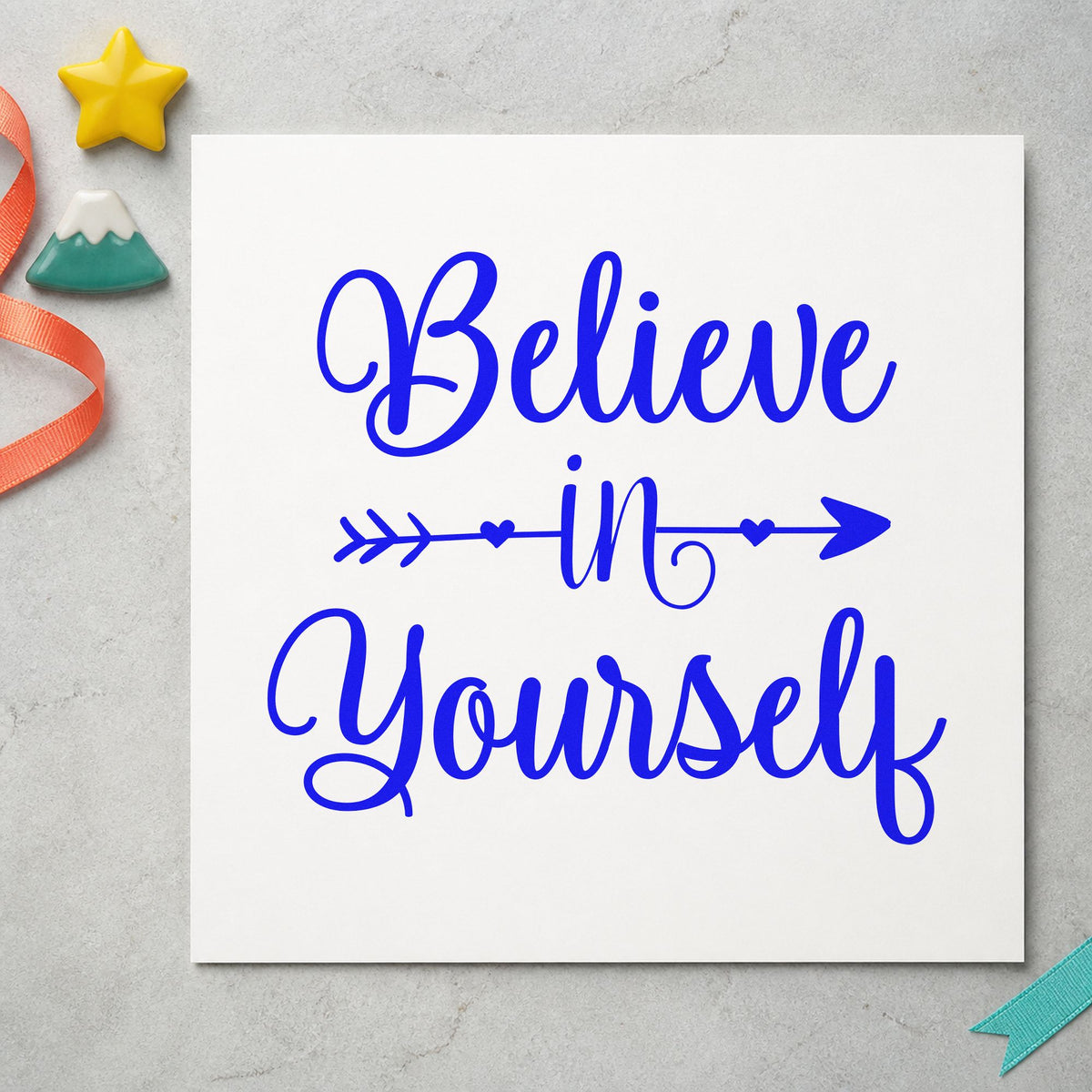 Believe In Yourself Arrow craft stamp imprinted in blue ink on paper, a design suited to framed studio mirror.