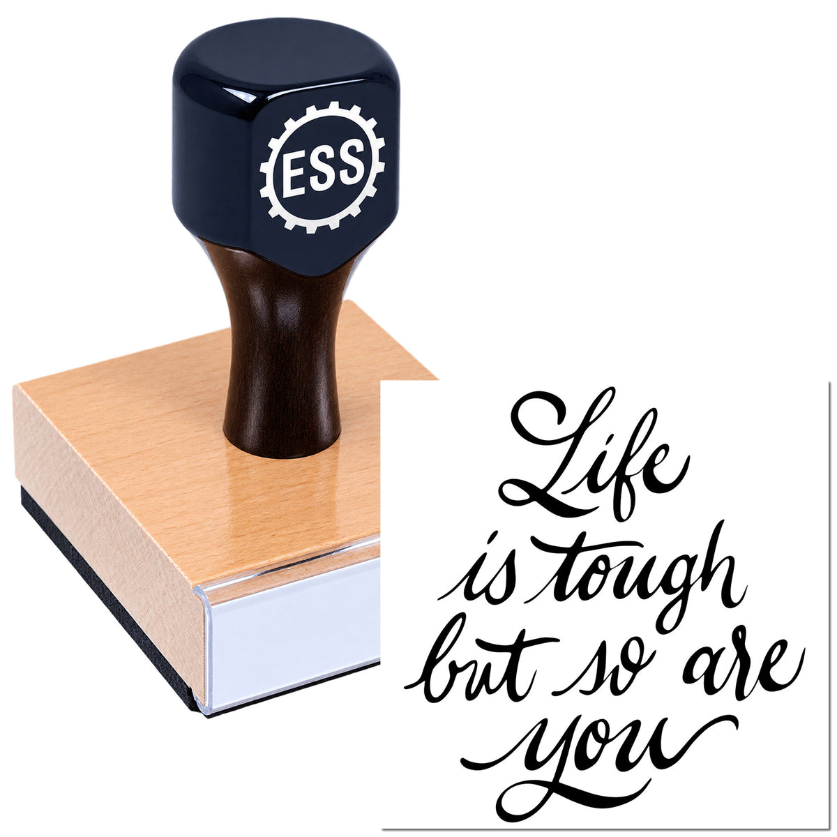 Dark navy ESS seal stamp on a pink wooden block, with cursive "Life is tough but so are you" design.