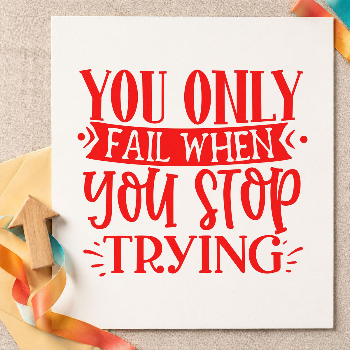 Only Fail When You Stop craft stamp imprint in red ink on a handmade project, one idea being route practice cards.