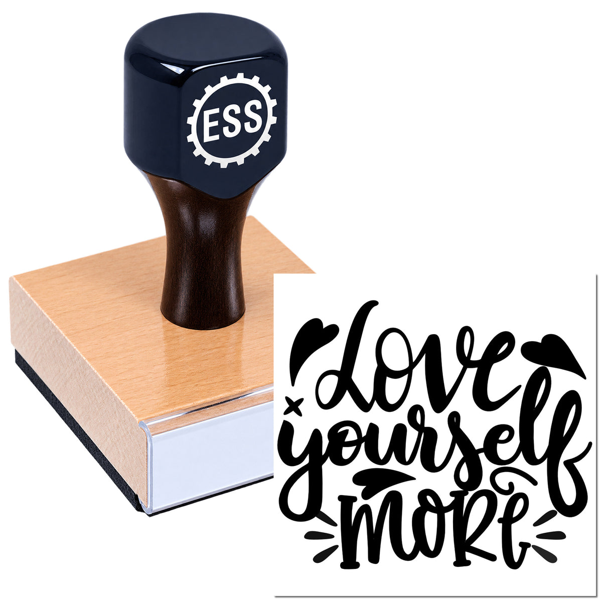Navy rubber stamp and seal on a pink block, printing black "love yourself more" script design.