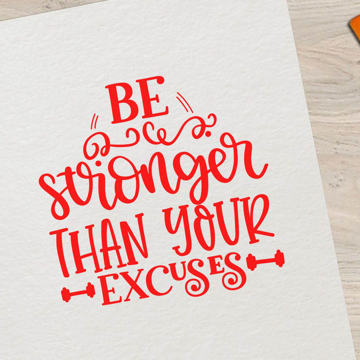 Red decorative stamp seal reading Be stronger than your excuses in bright red on white paper.