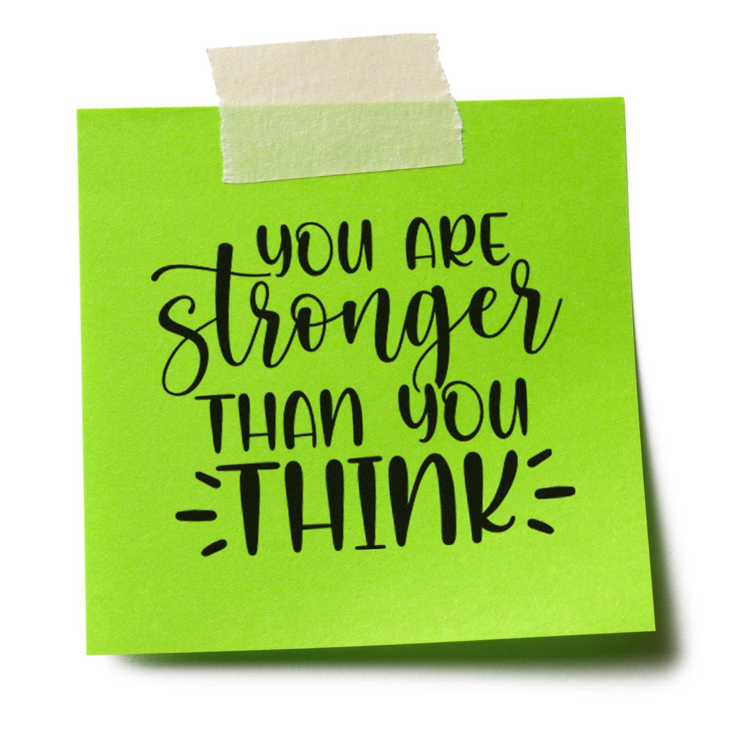 Bright green sticky note with black motivational stamp, taped at top with beige seal tape, reading You are stronger than you think.