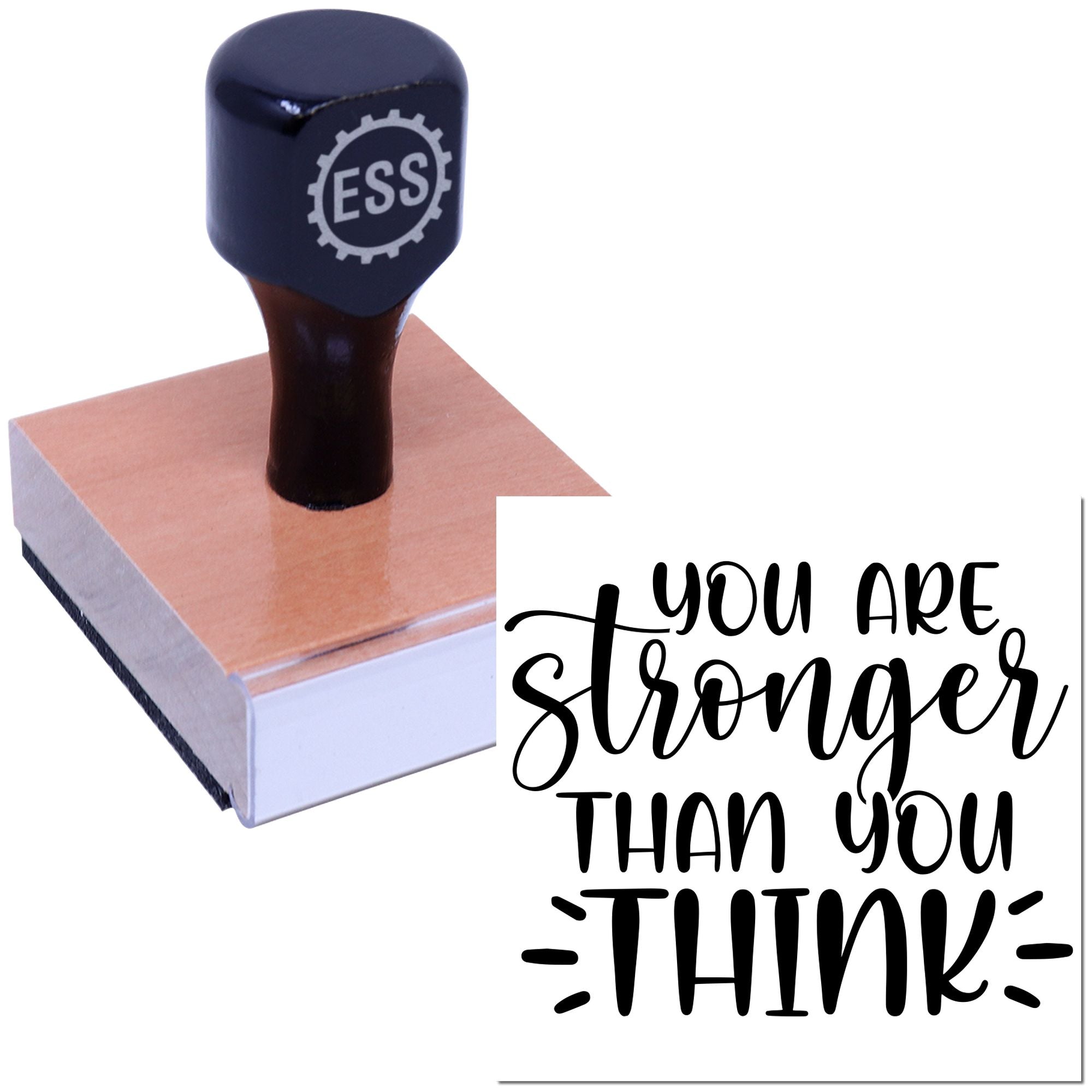 Dark blue rubber stamp seal with ESS logo on a wooden block beside a white card reading You are stronger than you think