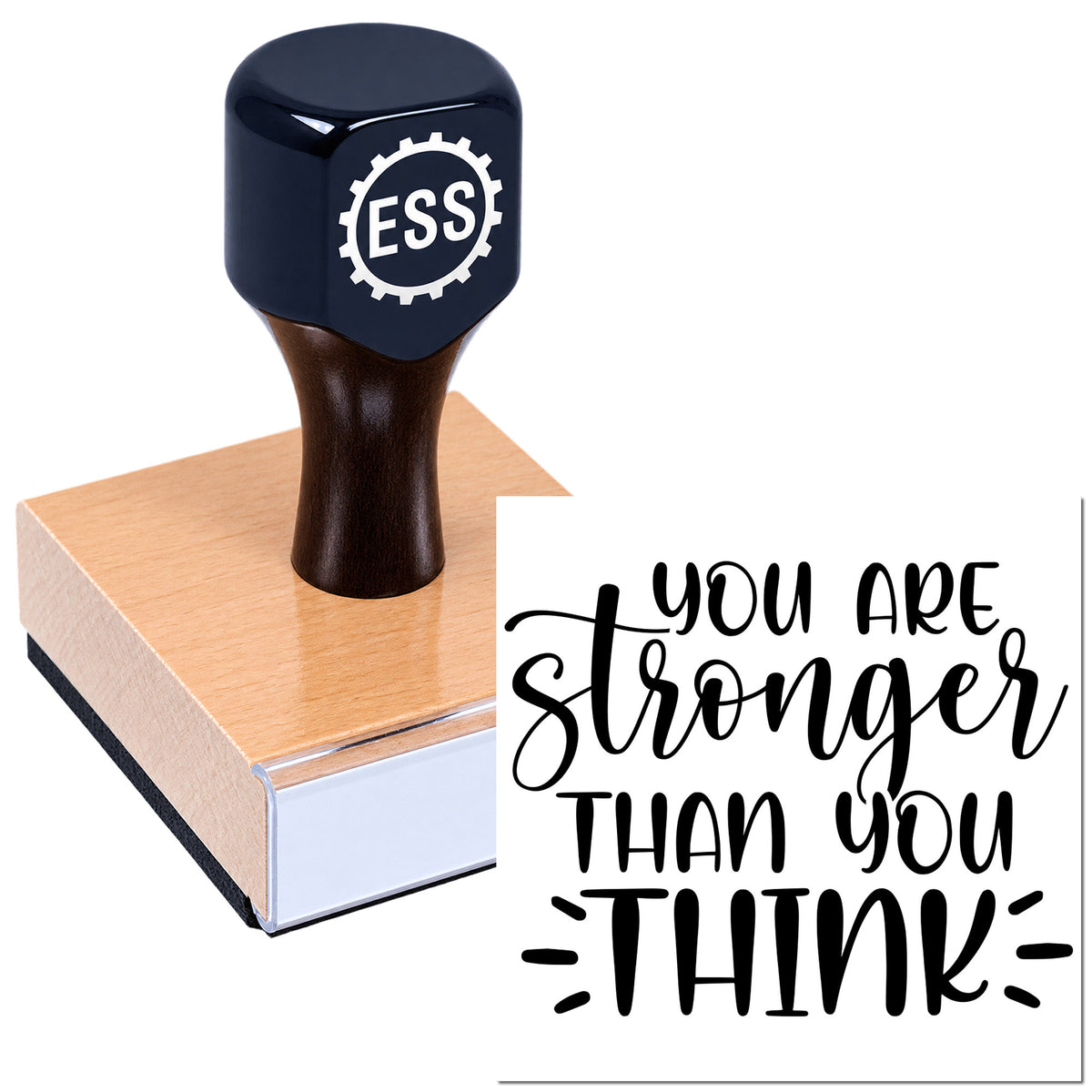 Dark blue rubber stamp seal with ESS logo on a wooden block beside a white card reading "You are stronger than you think"
