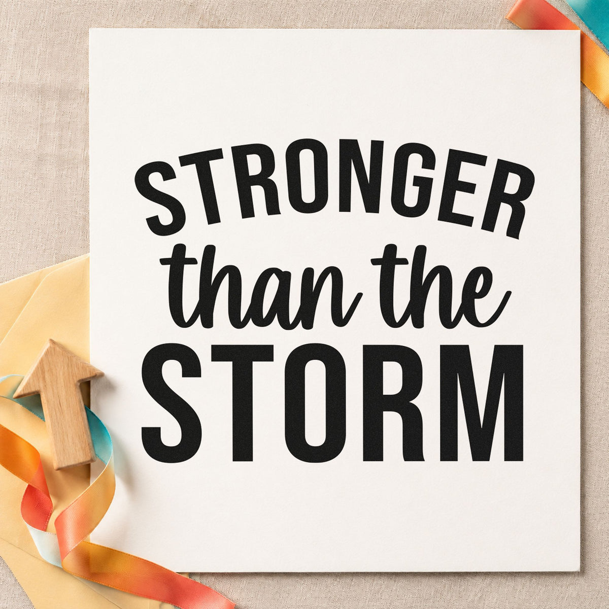 Stronger Than The Storm craft stamp imprint in black ink on a handmade project, one idea being supply drop gift tags.
