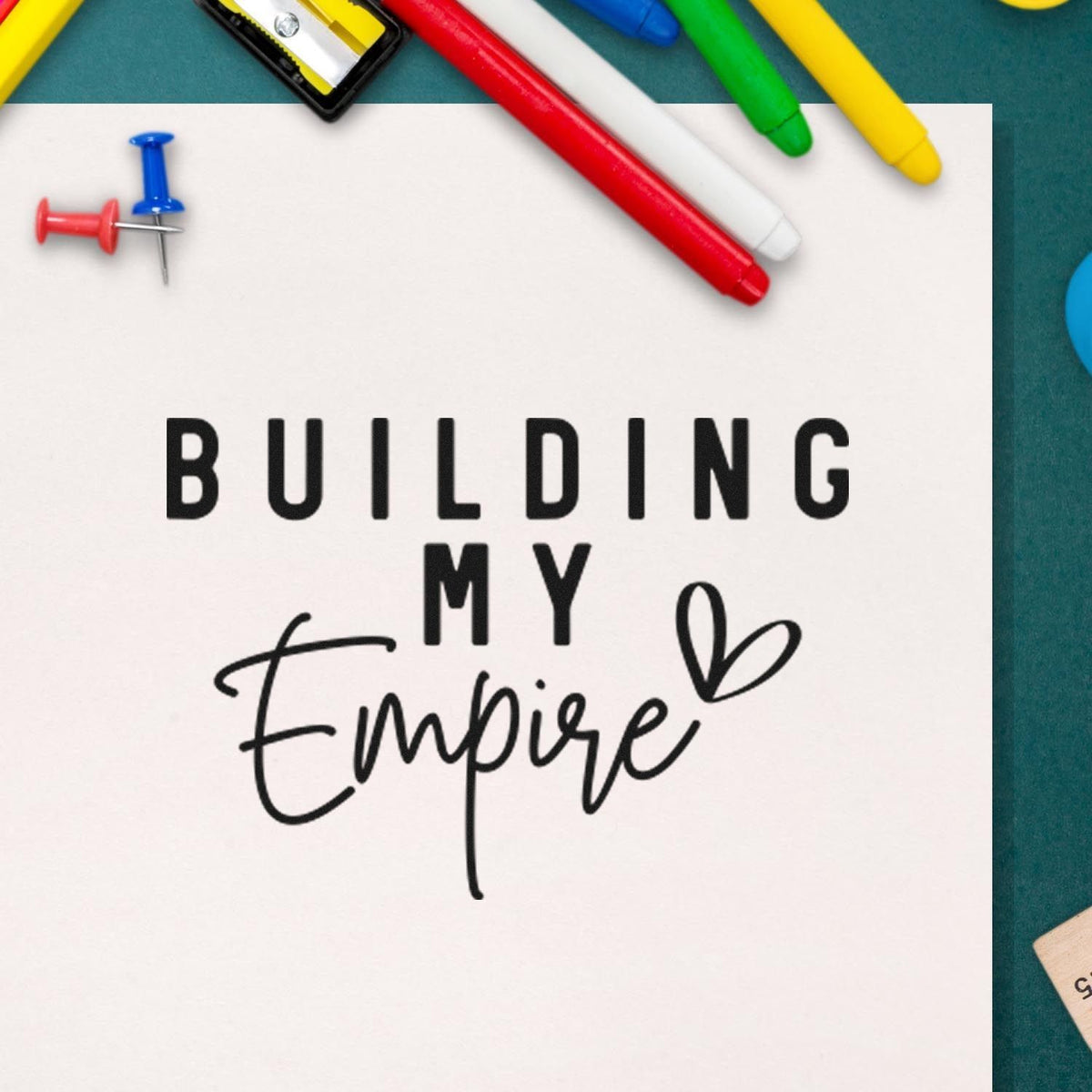Custom stamp and seal design reading Building My Empire in black, framed by red, blue, green, and yellow markers.