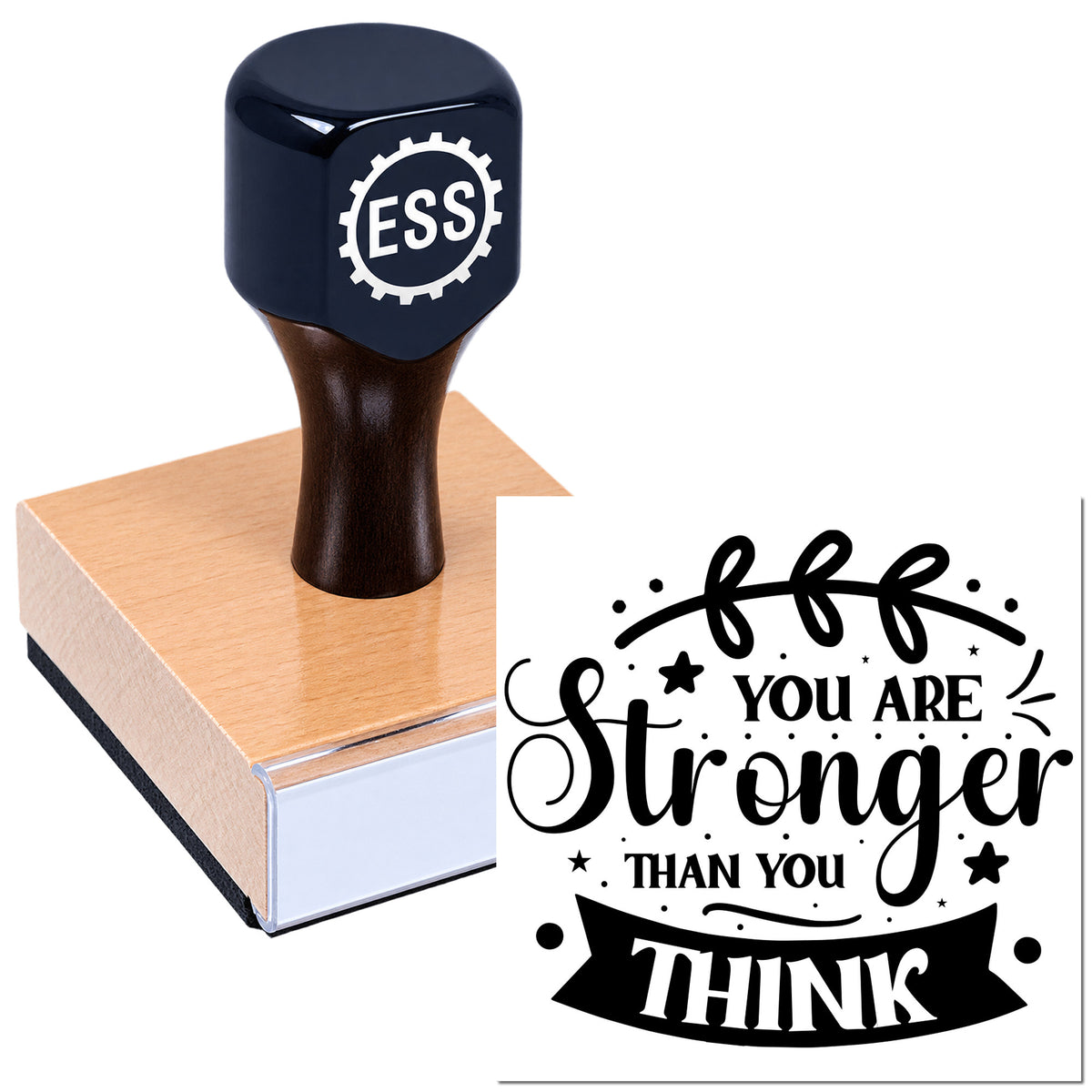 Dark blue ESS rubber stamp on a wooden block, creating a black "You Are Stronger Than You Think" seal on white.