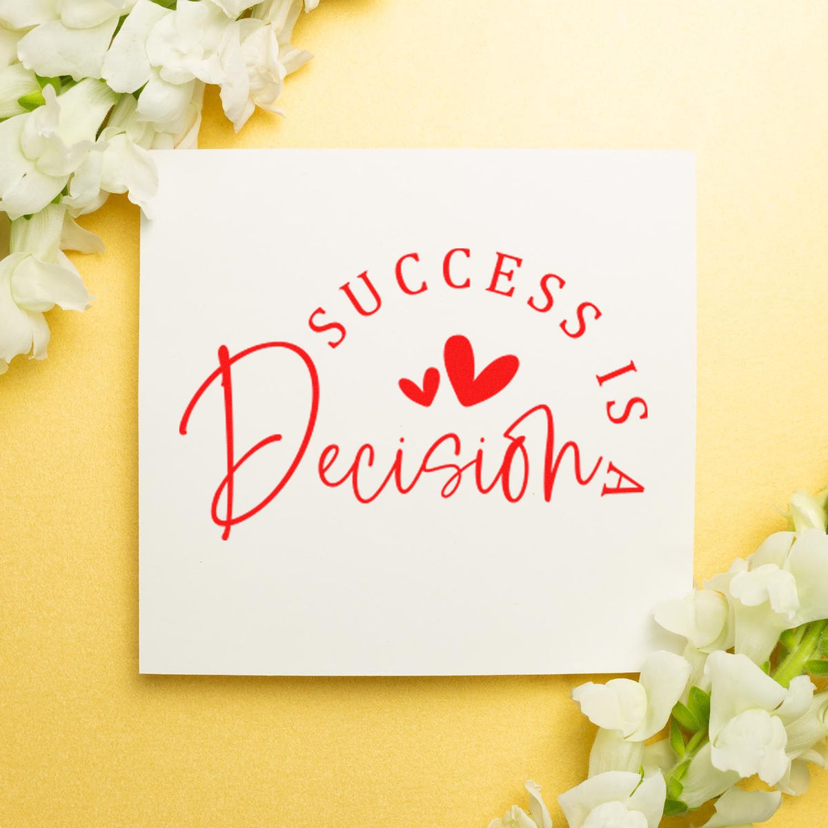 Red success stamp seal with hearts on a white card, surrounded by white flowers on a soft yellow background.