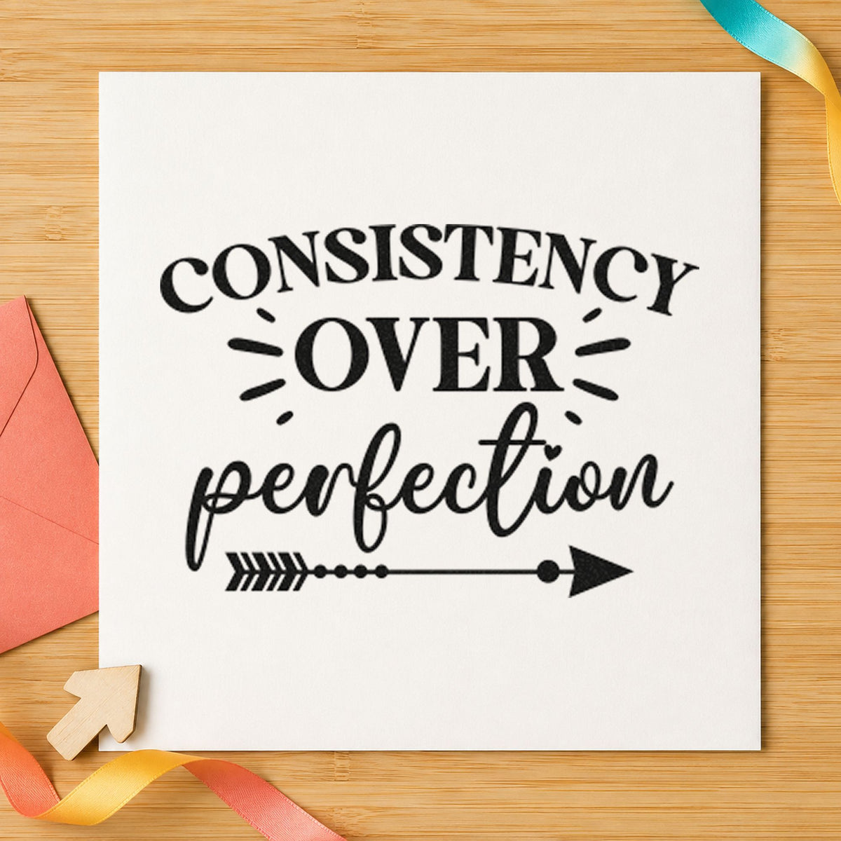Consistency Over Perfection Arrow craft stamp imprint in black ink on a handmade project, one idea being phrase book gift tags.