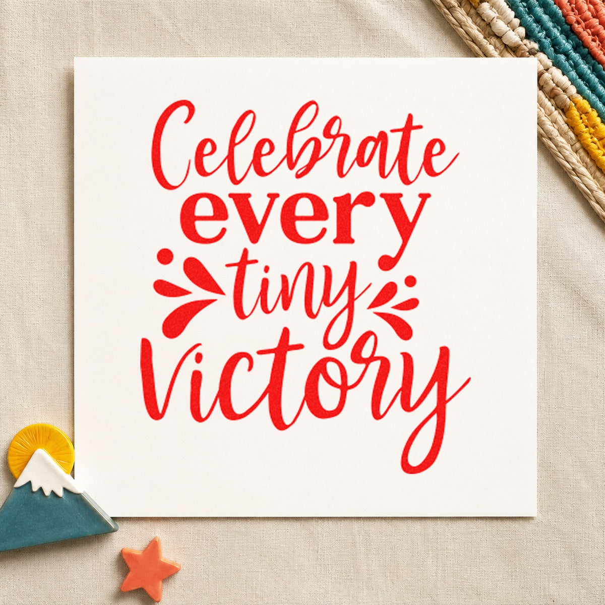 Celebrate Every Tiny Victory craft stamp imprint in red ink on a handmade project, one idea being small win cards.