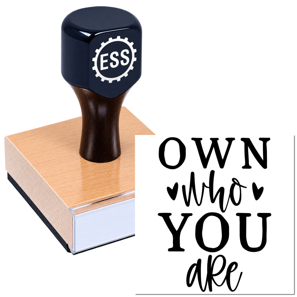 Dark blue custom rubber stamp on pink wooden block, with black "OWN who you are" seal design on white background.