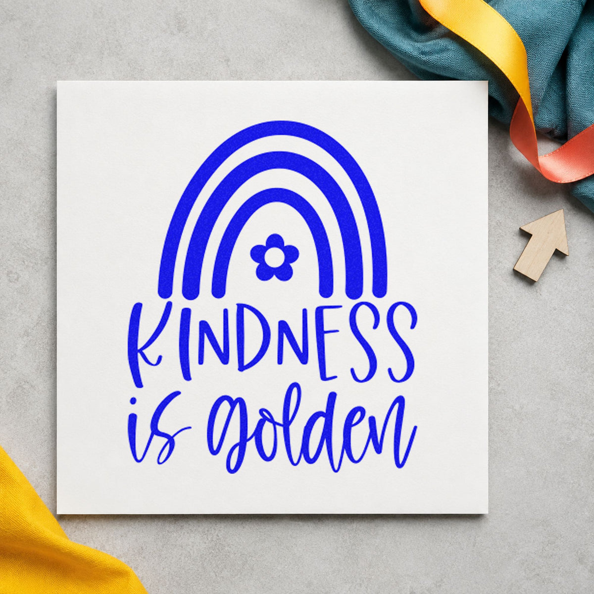 Kindness Is Golden Rainbow craft stamp in blue ink on cardstock, an easy option for safety vest printing.