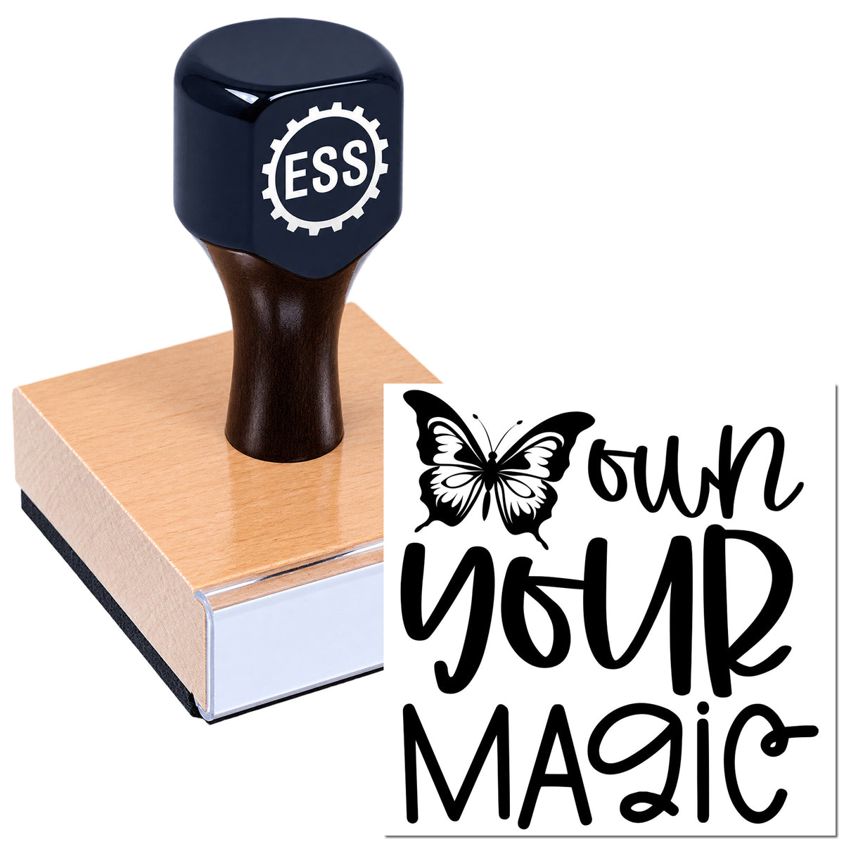 Black ESS custom rubber stamp on a wooden block with butterfly seal reading "Own Your Magic."