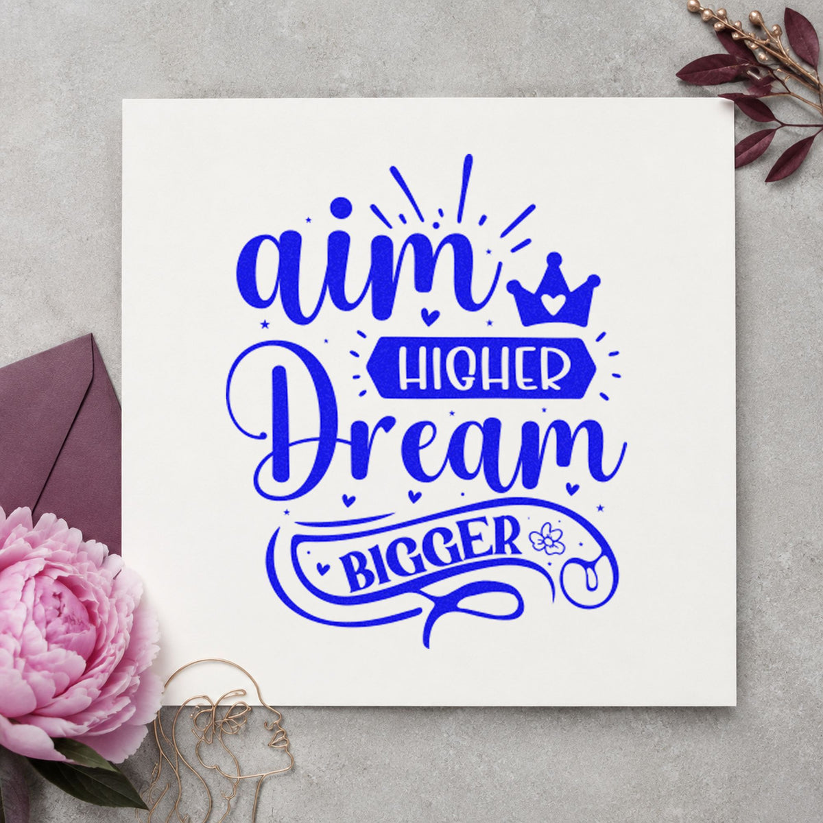 Aim Higher Dream Bigger Crown craft stamp imprinted in blue ink on paper, a design suited to framed gym tunnel.