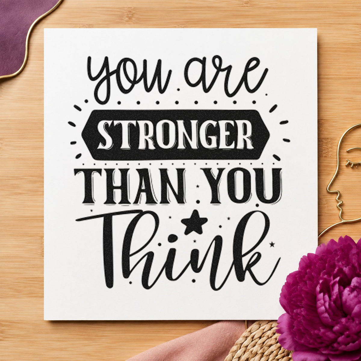 You Are Stronger Than Think craft stamp imprint in black ink on a handmade project, one idea being cap set gift tags.