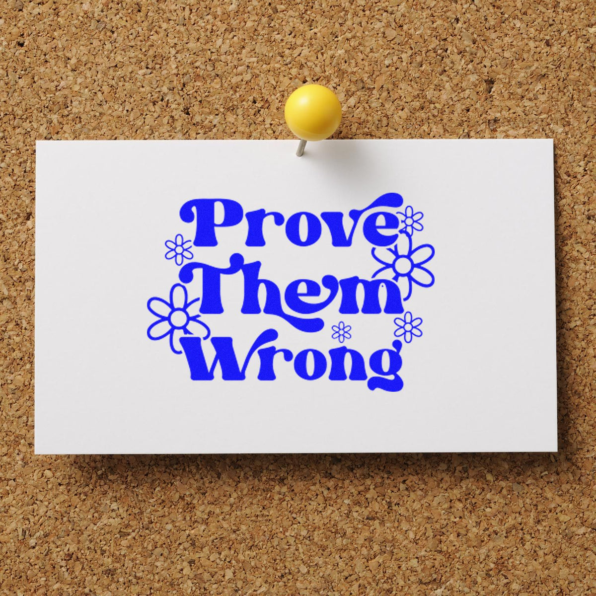 Pinned white card with bright blue custom stamp reading Prove Them Wrong, decorated with flowers.